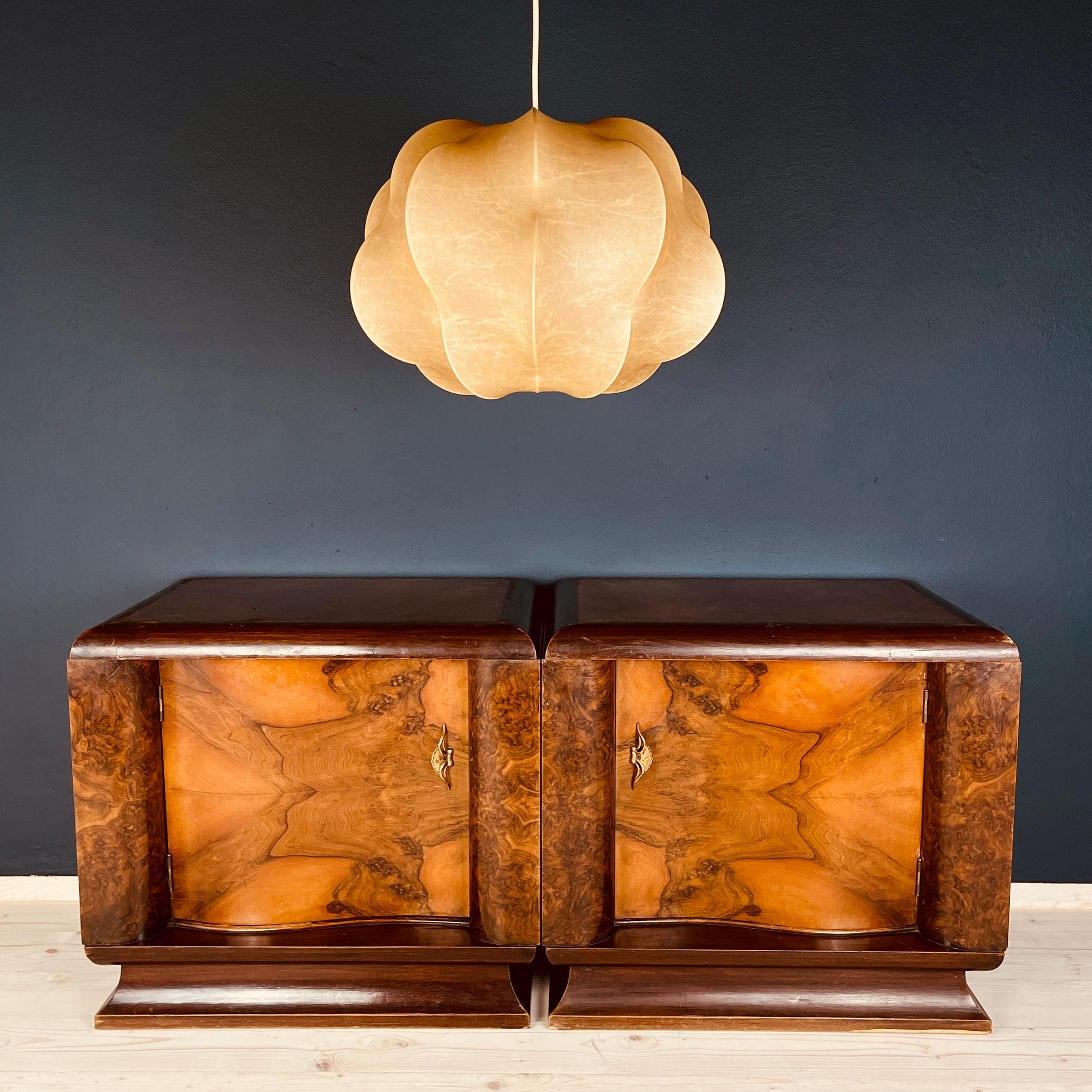 This pair of exquisite bedside tables hails from the 1950s in Italy, embodying the enduring elegance of mid-20th-century design. Crafted with a combination of solid wood, plywood, and adorned with stunning veneer, these tables showcase the artistry