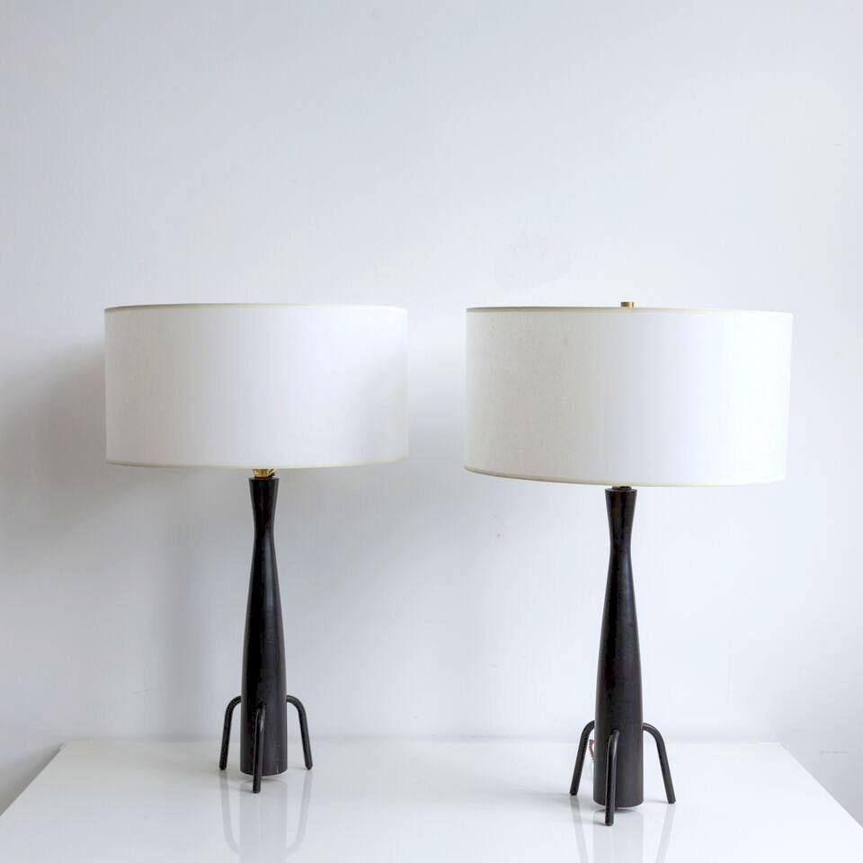Pair of wooden Paul McCobb table lamps. Providing visual interest, these unique lamps would be the perfect accompaniment to flank a sofa or for nightstands. Each lamp base measures 29