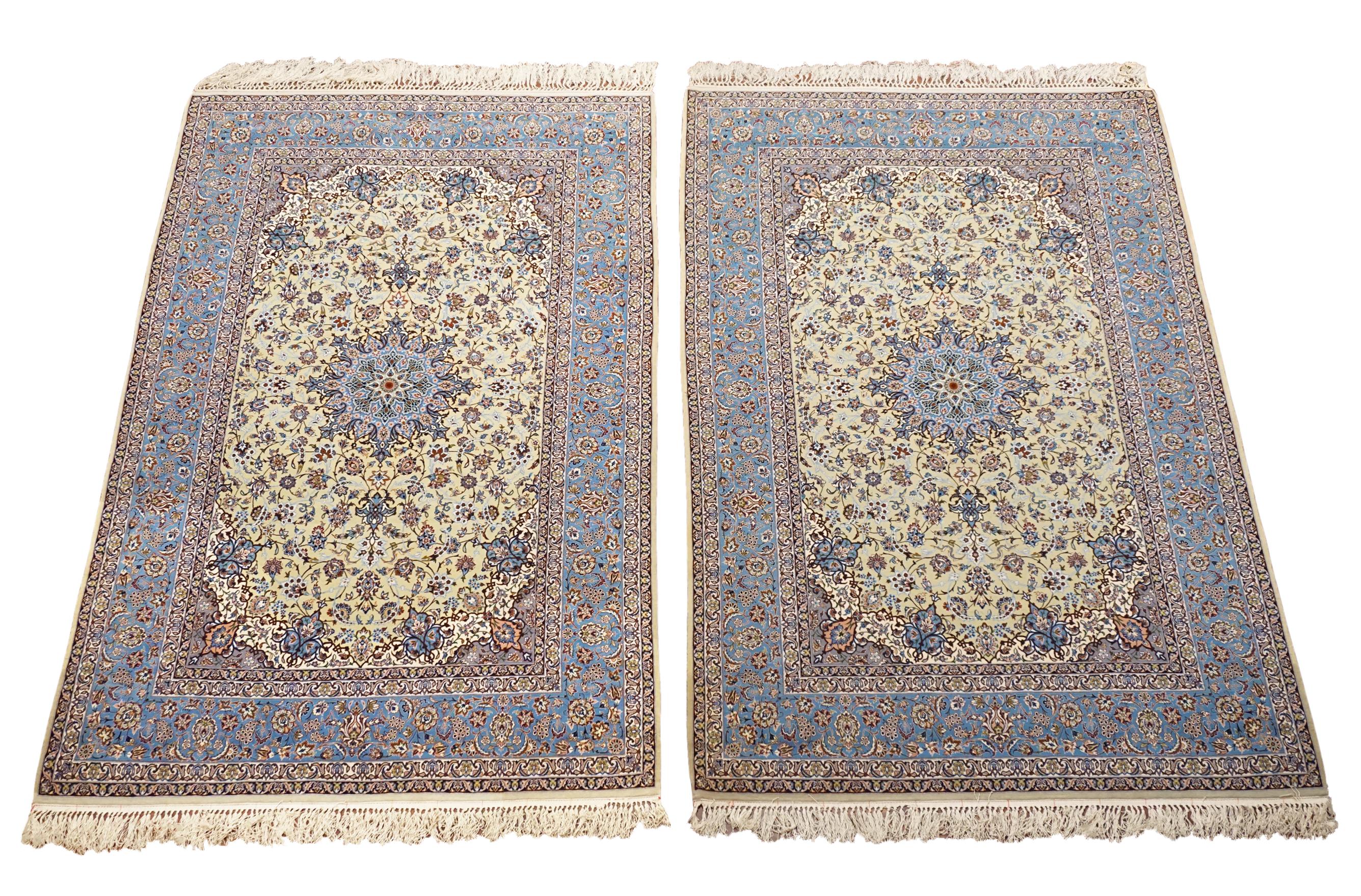 Set of two 

Hand-knotted wool & silk pile on a cotton foundation.

Circa 1970

Dimensions: 5' x 8' (Each) 

Origin: Iran

Field Color: Pale-Green  

Border Color: Blue 

Accent Colors: Navy-Blue, Ivory, Plum, Burgundy, Olive-Green 