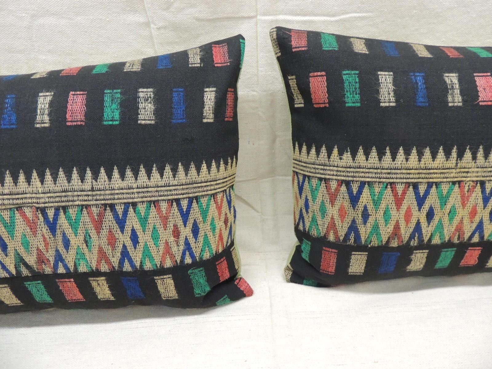 Pair of vintage woven colorful Laos woven silk decorative lumbar pillows
Decorative pillows finished with green silk backings.
In shades of green, black, yellow, orange, red, turquoise and blue.
Laotian textile throw pillows designed and
