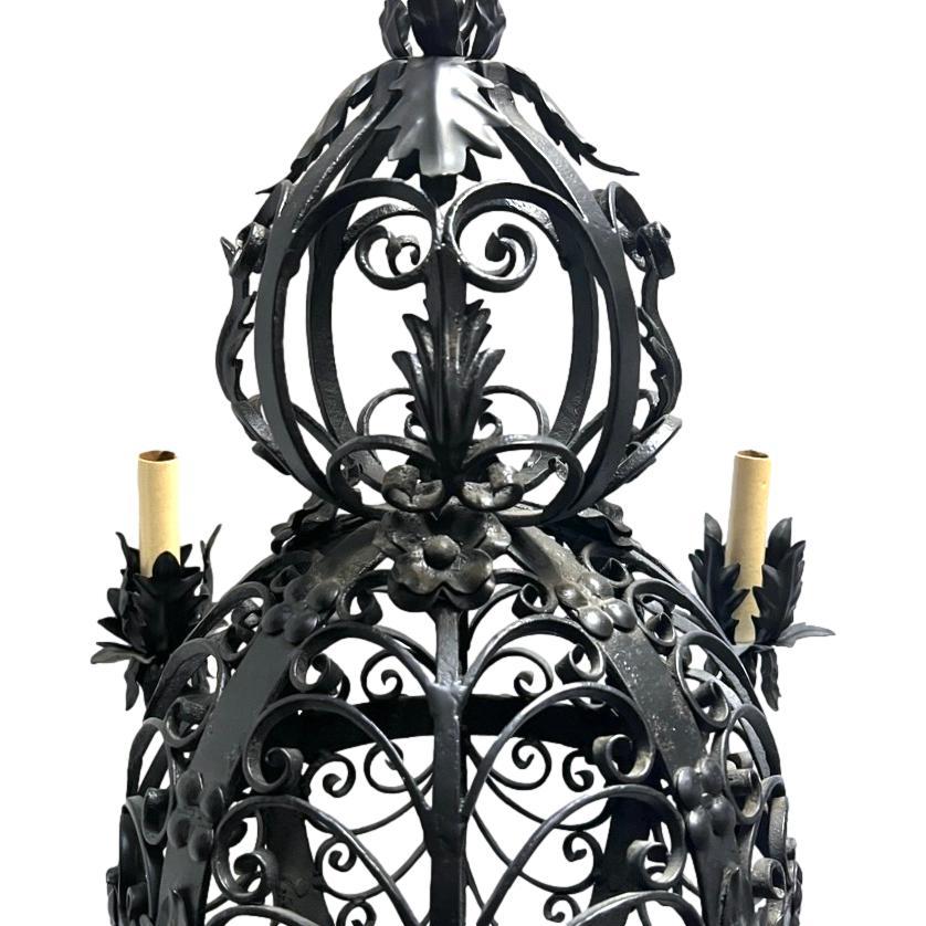 A pair of French circa 1930's wrought iron chandeliers with 4 lights each. Sold individually.

Measurements:
Drop: 30