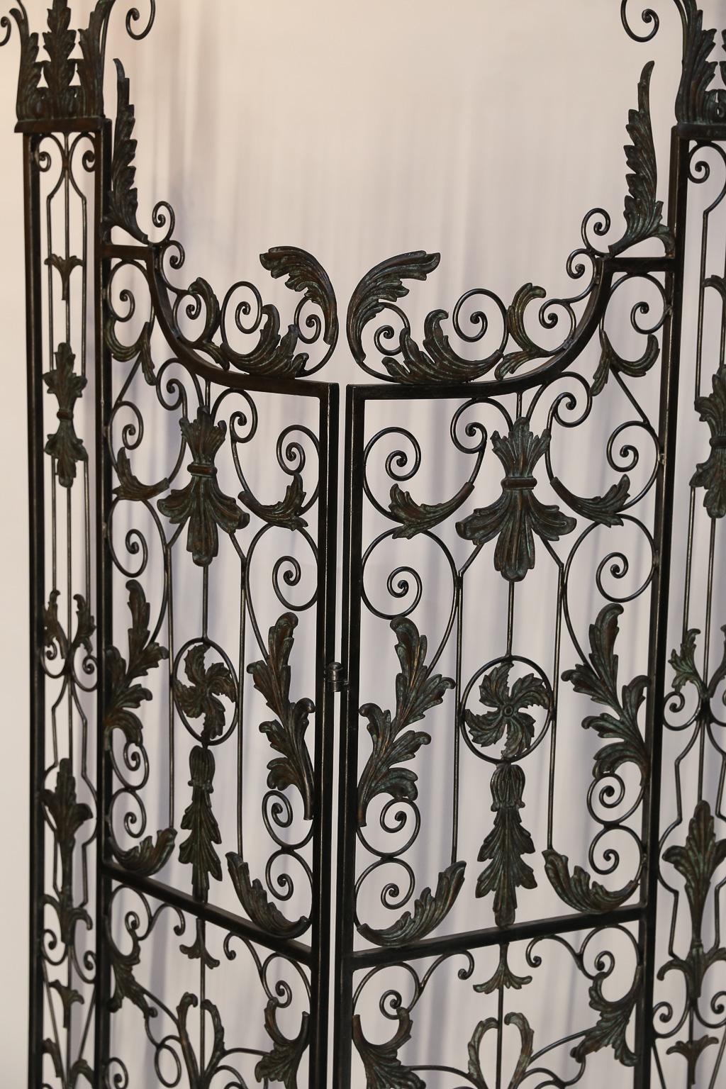 Pair of vintage wrought iron Filigree Gates decorated with acanthus leaves and fleur de lis in the various patterns.