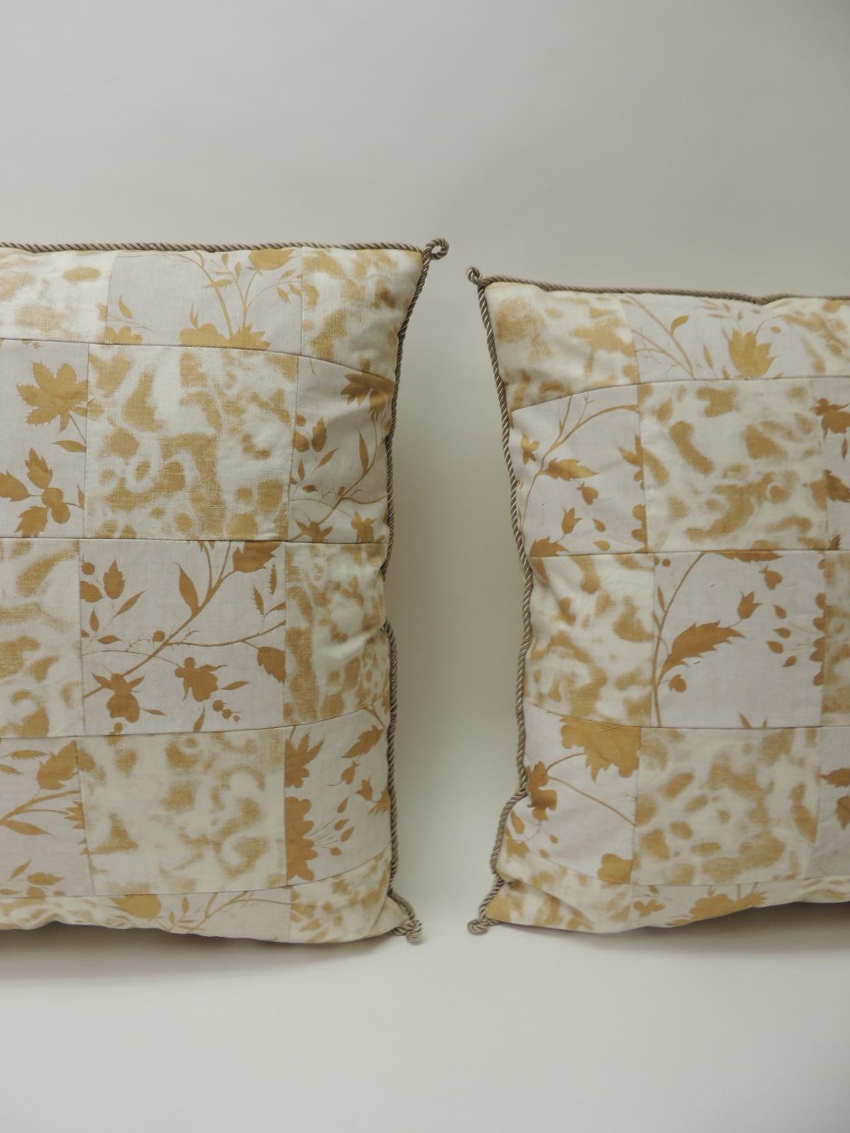 Pair of vintage yellow and natural Fortuny patchwork square decorative handcrafted pillows with ATG custom patchwork design. Decorative pillows embellished with silk grey rope trim all around. Backing of the pillows finished with ecru silk.
