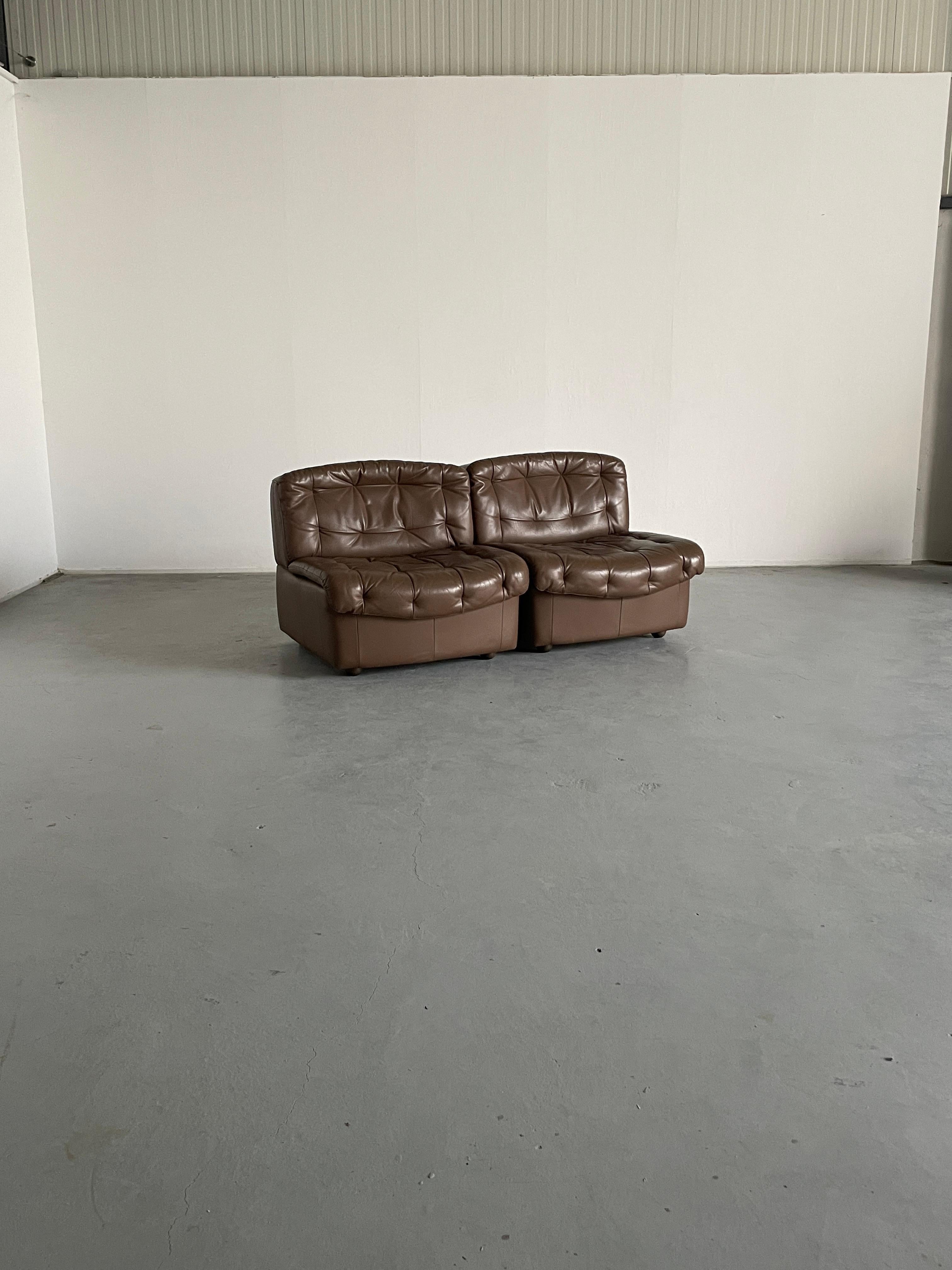 Pair of vintage Italian Mid-Century Modern leather lounge chairs or club chairs. 
Two individual modules.
Beautiful and unique shape and a quality 1970-1975 production.
In the style of De Sede DS-11 modular sofa.

Overall very well preserved and in