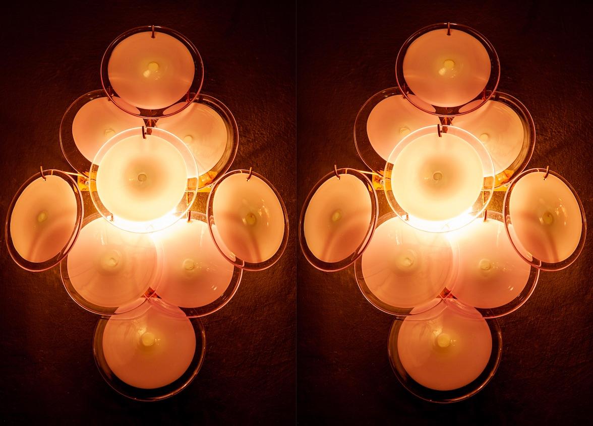 Pair of sconces with nine amber Murano glass discs.
Available also with white and amethyst color.
 
