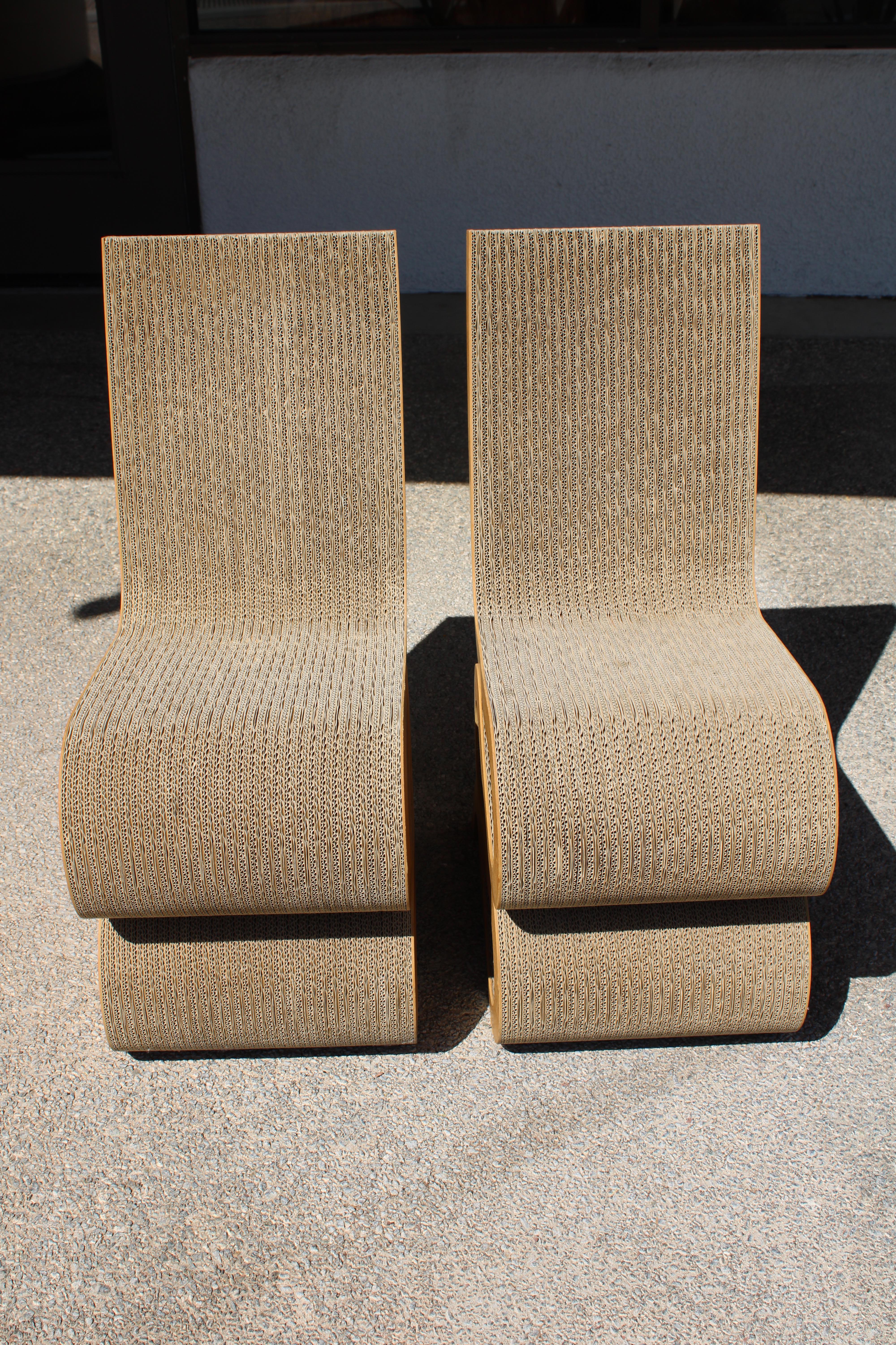 Corrugated cardboard wiggle side chair designed by Frank O. Gehry and reissued by Vitra. Each chair measures 14