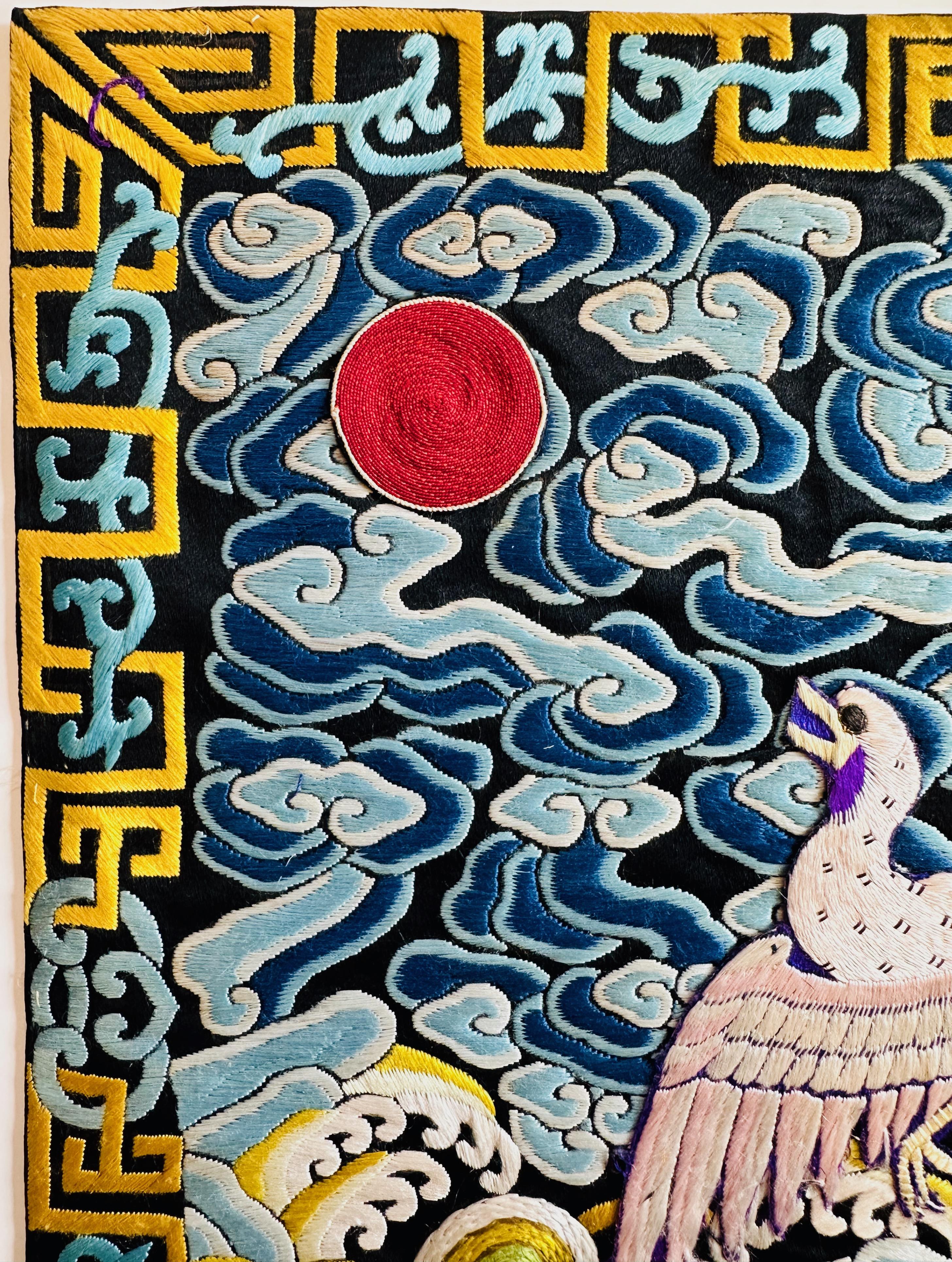 Vividly colored pair of 19th century civil rank badges (buzi) decorated with an egret, denoting a civil servant of the Sixth Rank. The badges are worked in flat stitch embroidery on a dark blue silk background, with the bird tinged slightly pink,