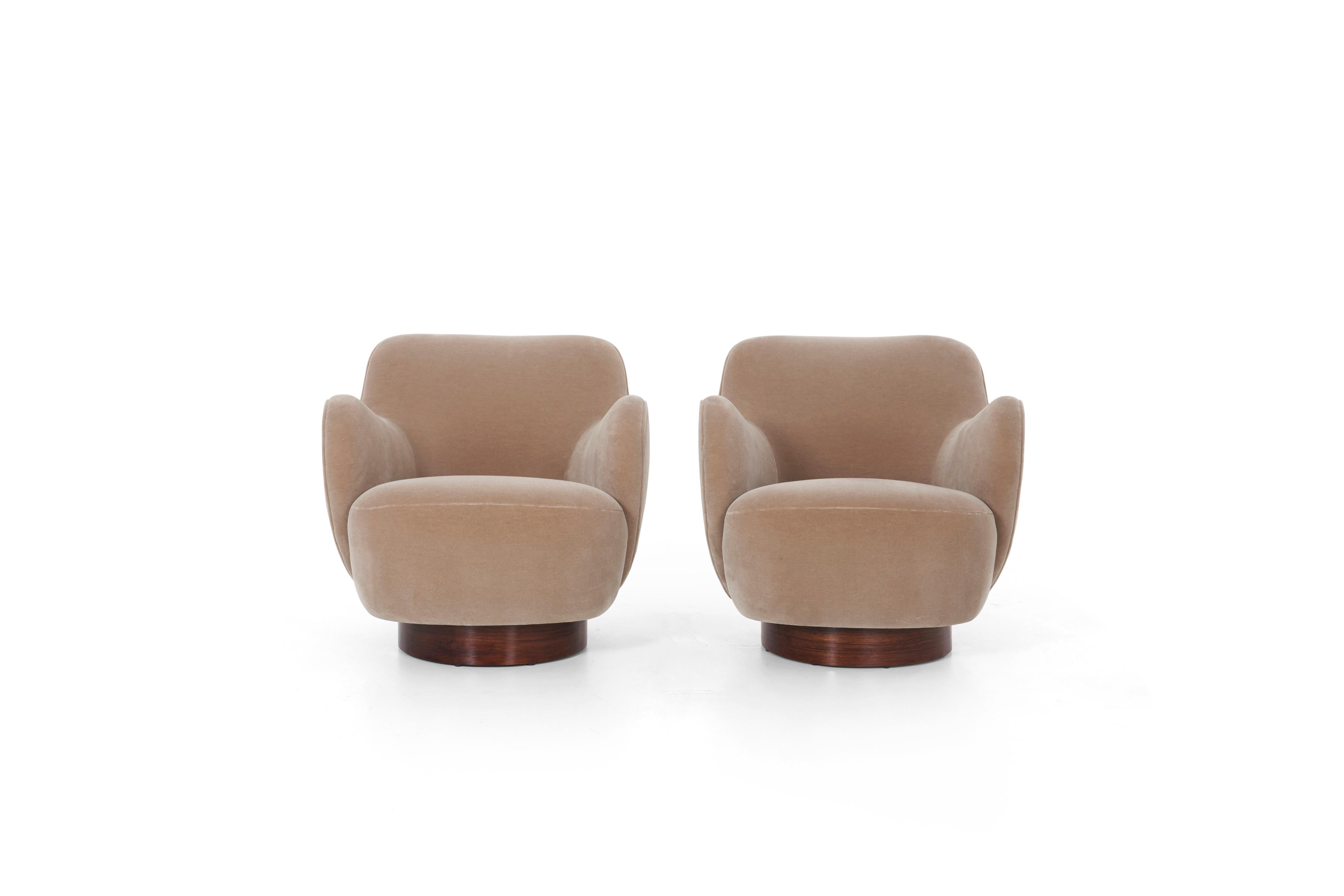 Kagan-Dreyfuss, Inc. Barrel lounge chairs model 100a, tilt and swivel. Reupholstered with Great Plains Mohair, rosewood plinth bases oil finish.
 