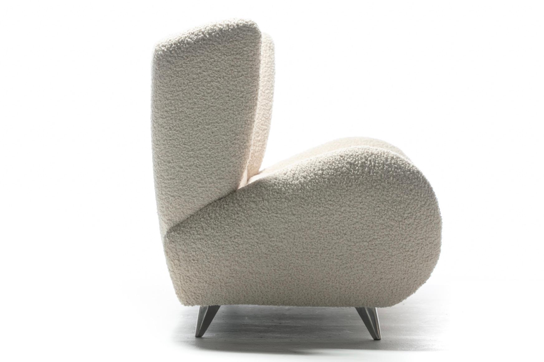 A love for his 1950s wingback design motivated Vladimir Kagan to circle back and produce a more contemporary version he later named the Fiftyish Sofa. Vladimir Kagan's tendency to over emphasize curves is evident in this sofa's design. True to that