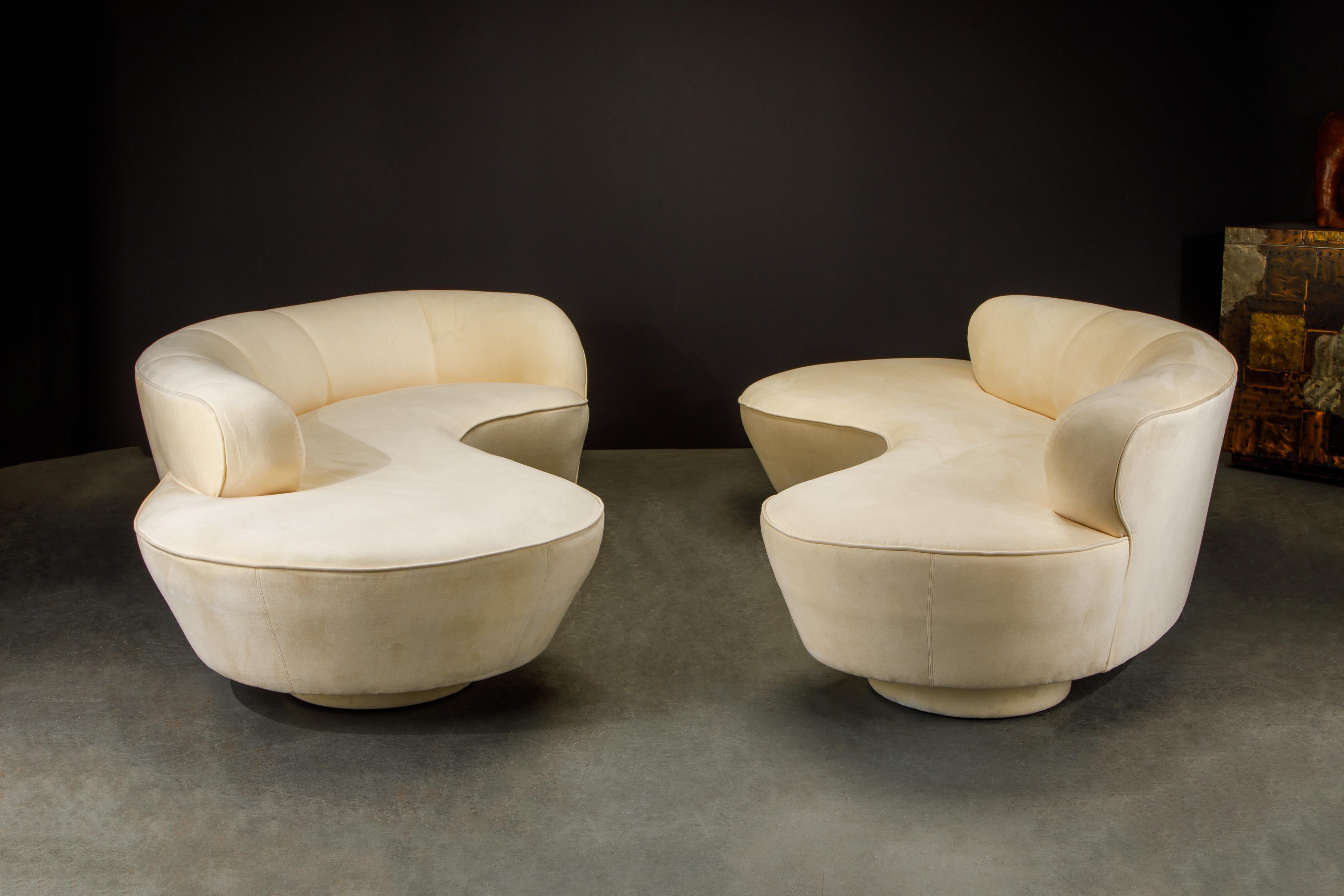 This mesmerizing pair of Vladimir Kagan 'Cloud' sofas were produced by Directional in circa 1980 and in their original soft cream-colored Alcantara fabric with lucite center legs, both sofas signed underneath with Directional labels. Collectors and