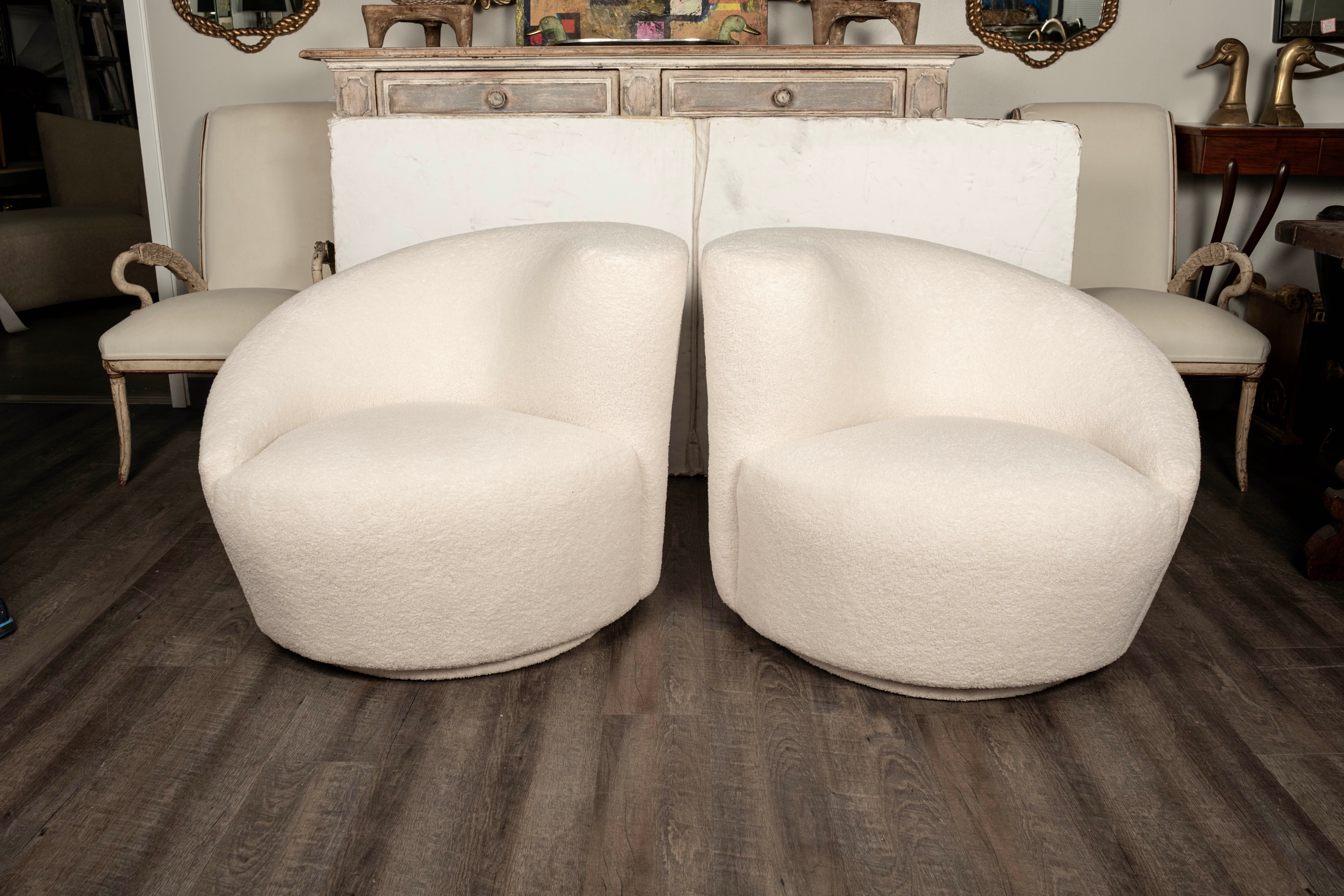 Outstanding pair of Vladimir Kagan for Directional Style Nautilus swivel chairs. This stunning true opposing pair of Kagan Postmodern Nautilus swivel chairs or corkscrew swivel chairs have been professionally upholstered in premium white boucle