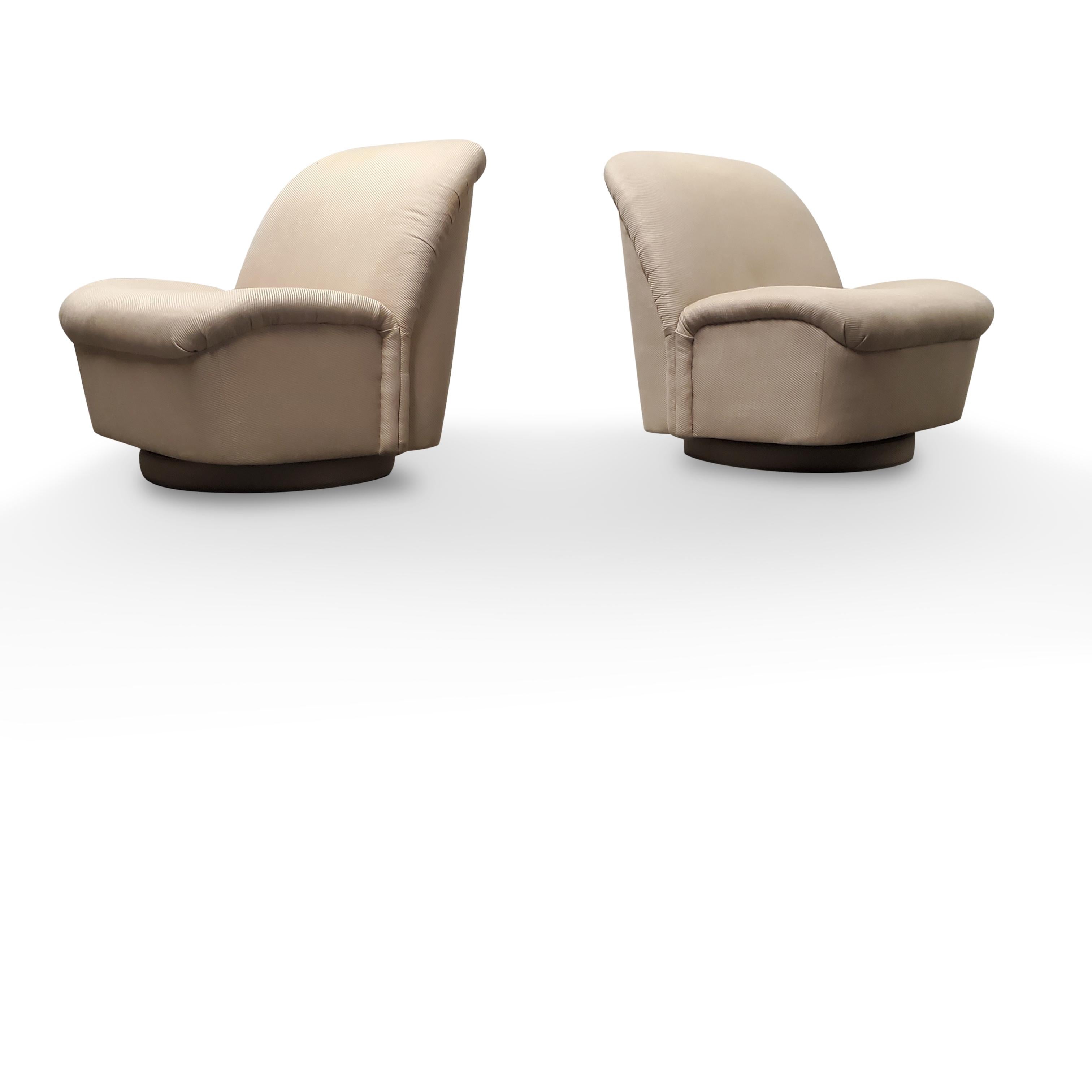 Pair of Signed Directional Swivel / Tilt lounge chairs.