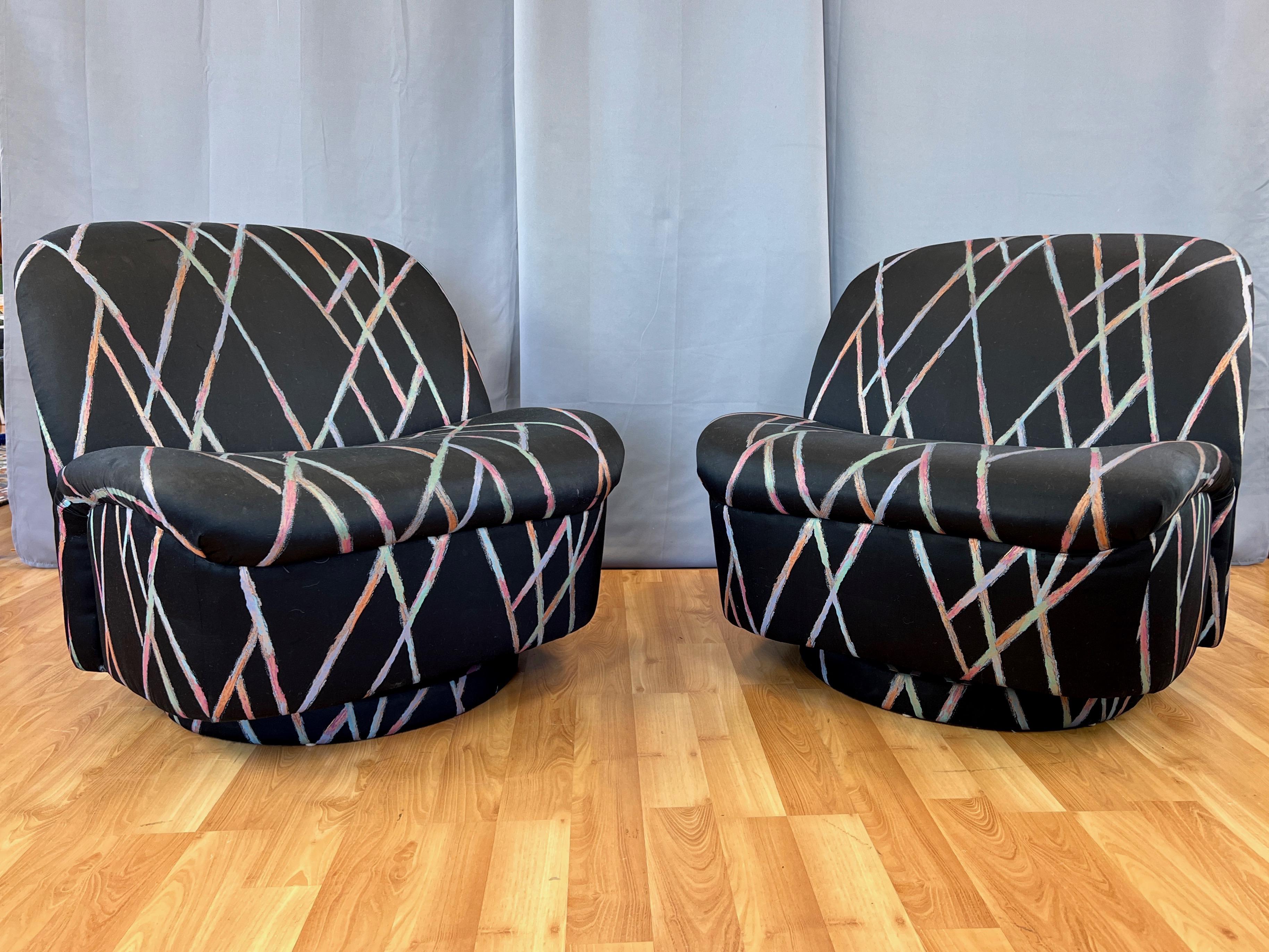A fabulous pair of 1980s swiveling & tilting slipper-style lounge chairs in their original upholstery by Directional, who referred to the design in original advertisements as a “swivel lip chair”.

Generously-sized and inviting slipper seat with