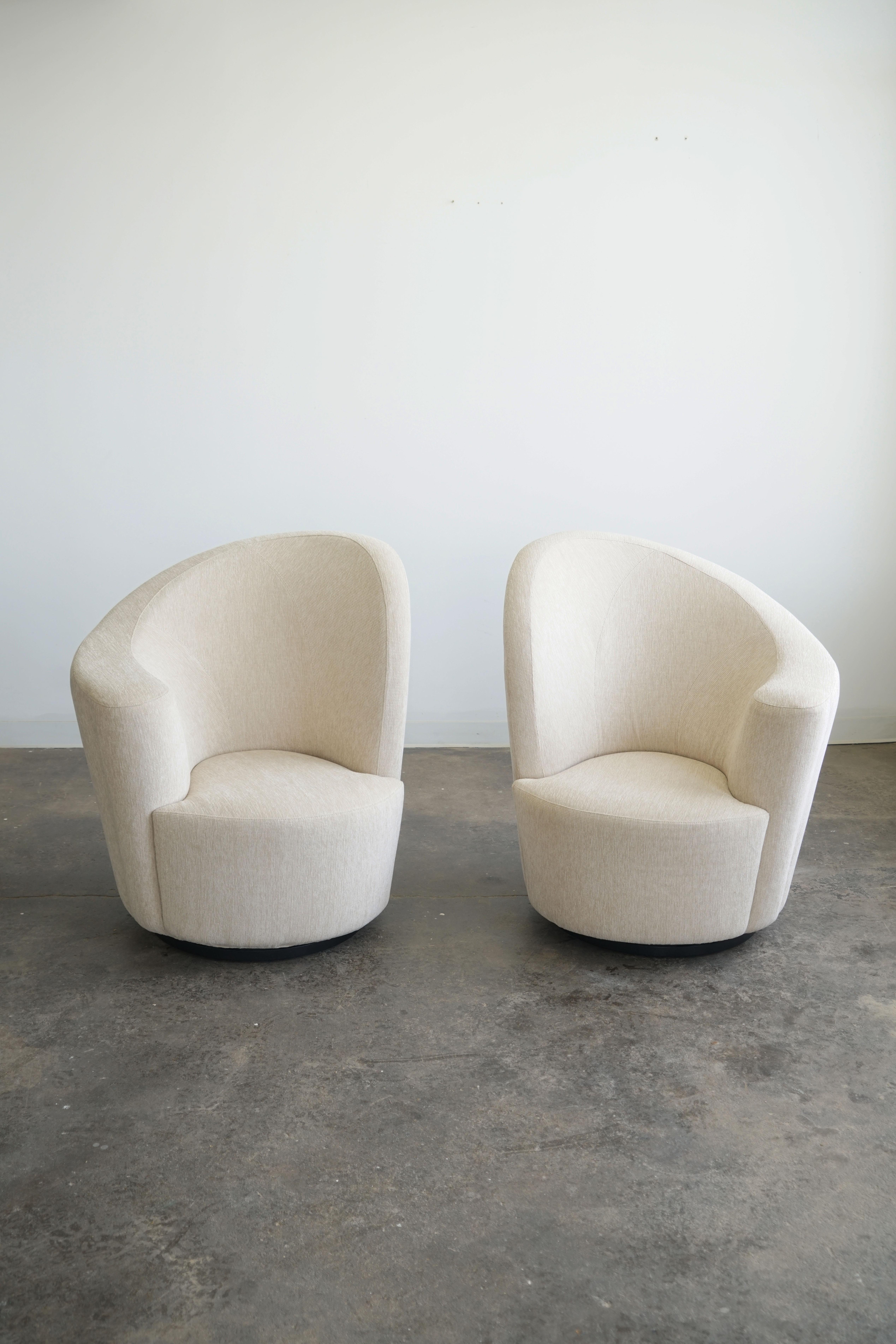 A pair of gorgeous swivel armchairs that are 