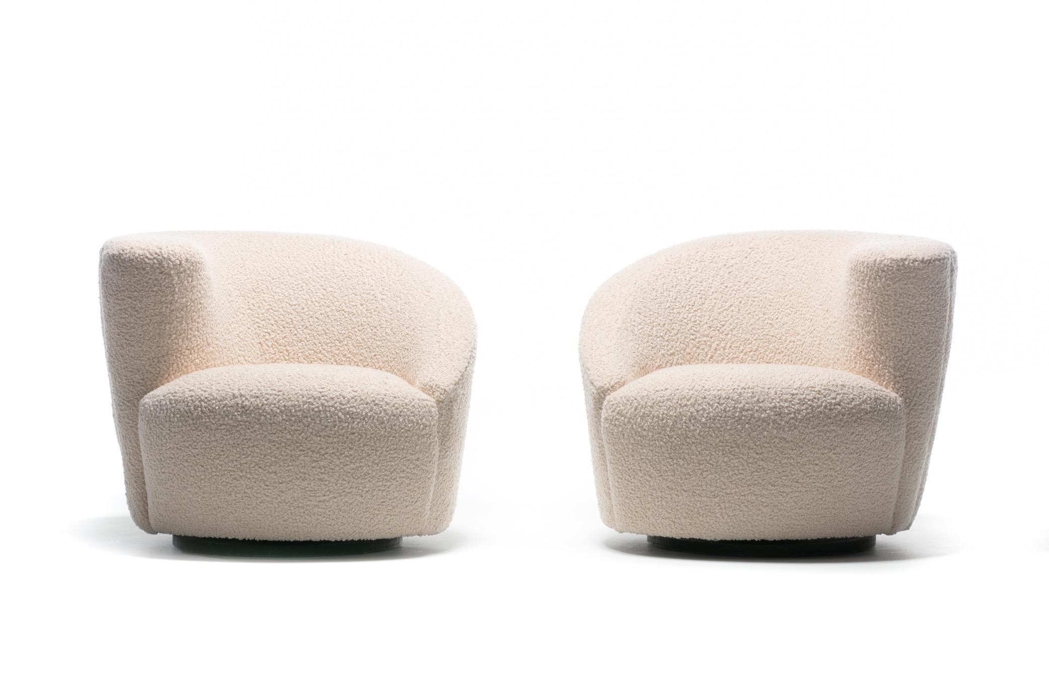 Amongst the most popular Vladimir Kagan designs, these Nautilus swivel lounge chairs are sculptural, comfortable and fun, and were recently professionally reupholstered in cozy Ivory Boucle. Corkscrew shape with sloped back and arm. The Nautilus