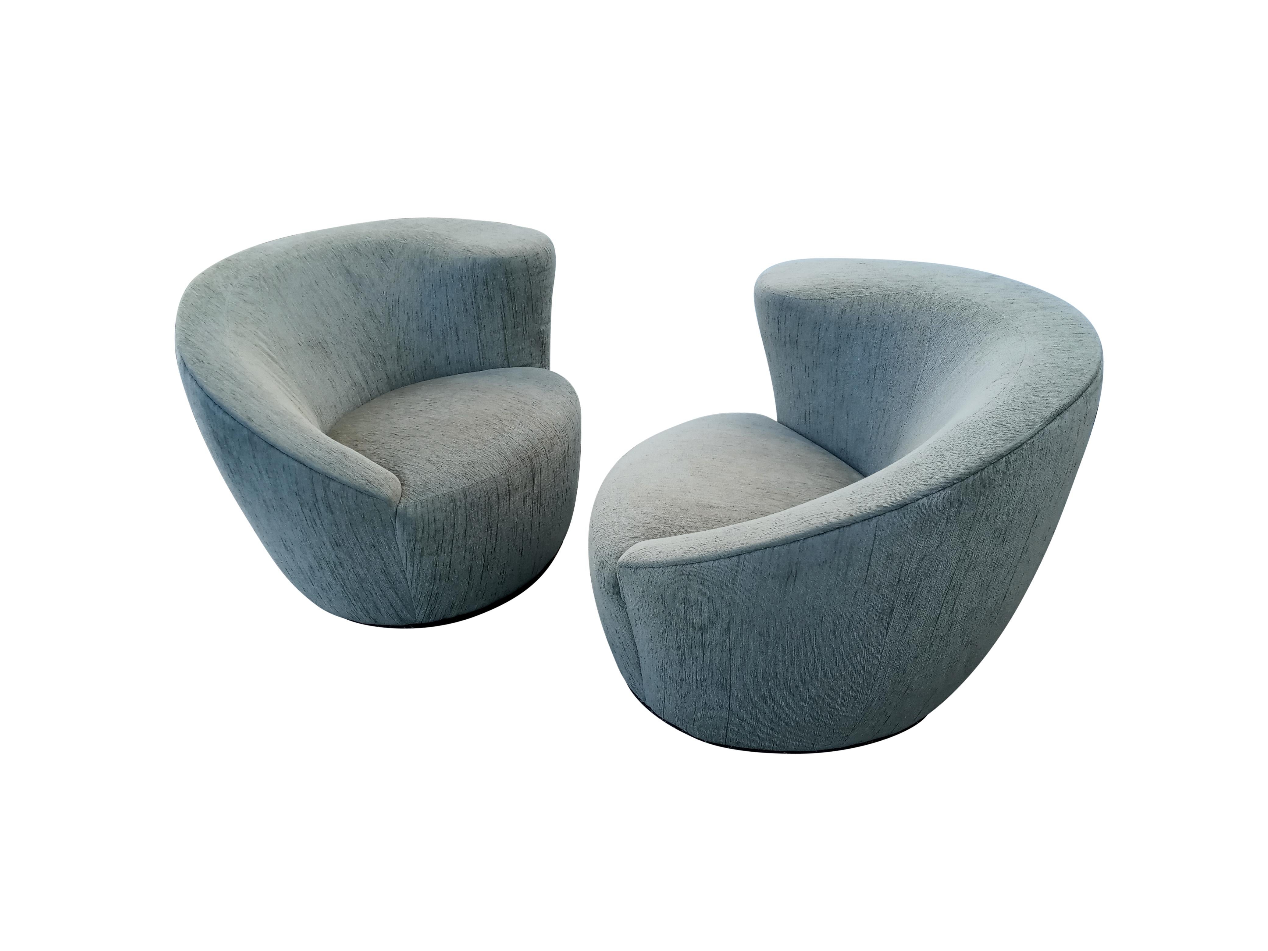 This pair of very attractive Nautilus chairs have a sculptural profile that is only rivaled by how extremely comfortable they are. The fully upholstered forms are mounted on a thick flat black painted wooden base with a spring loaded lazy-susan