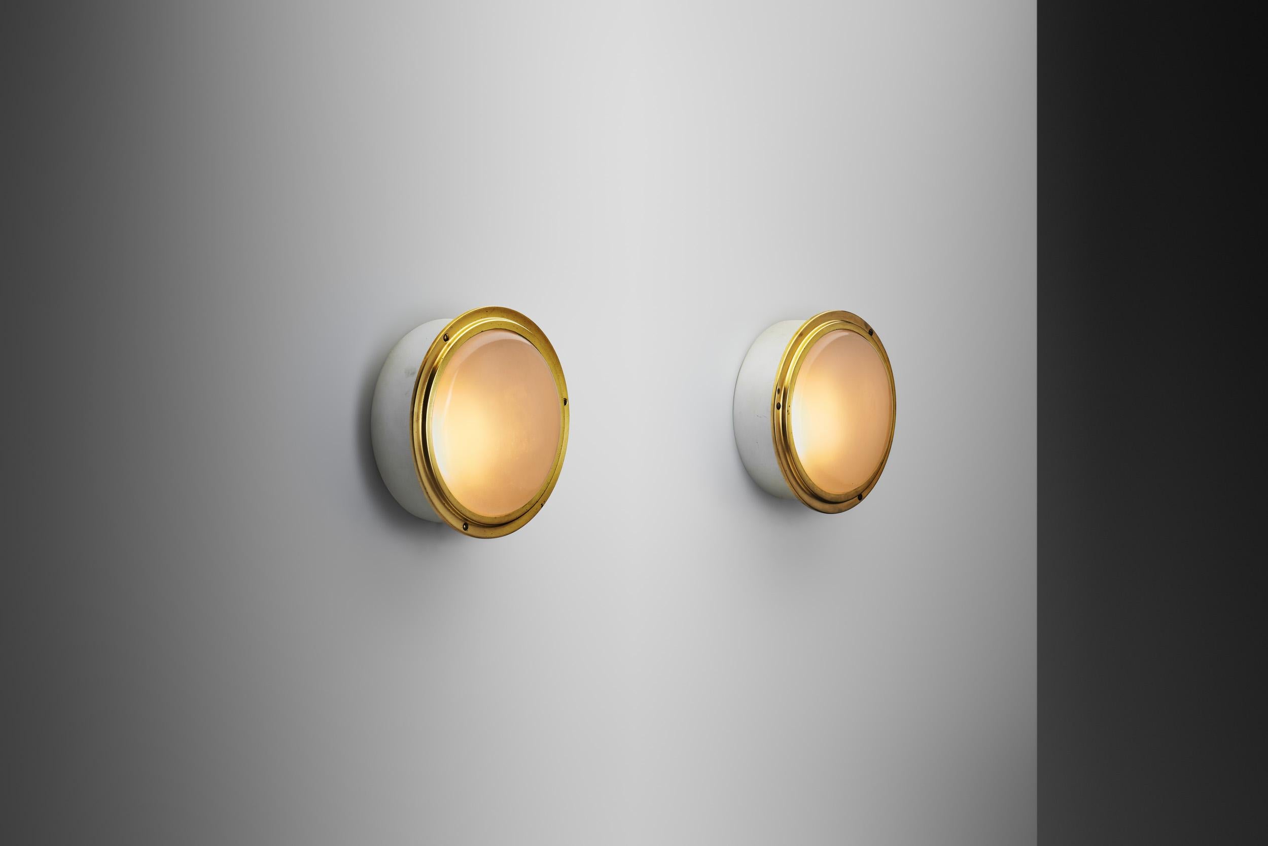 This pair of Louis Poulsen 'Waggon' wall lamps are quintessential representations of Danish modern design, characterized by simplicity, functionality, and a distinct minimalist aesthetic. These lamps, with their combination of high-quality