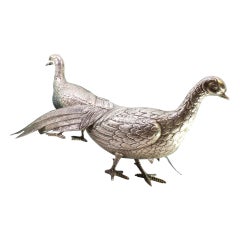 Pair of walking pheasants in silver with reliefs and applications