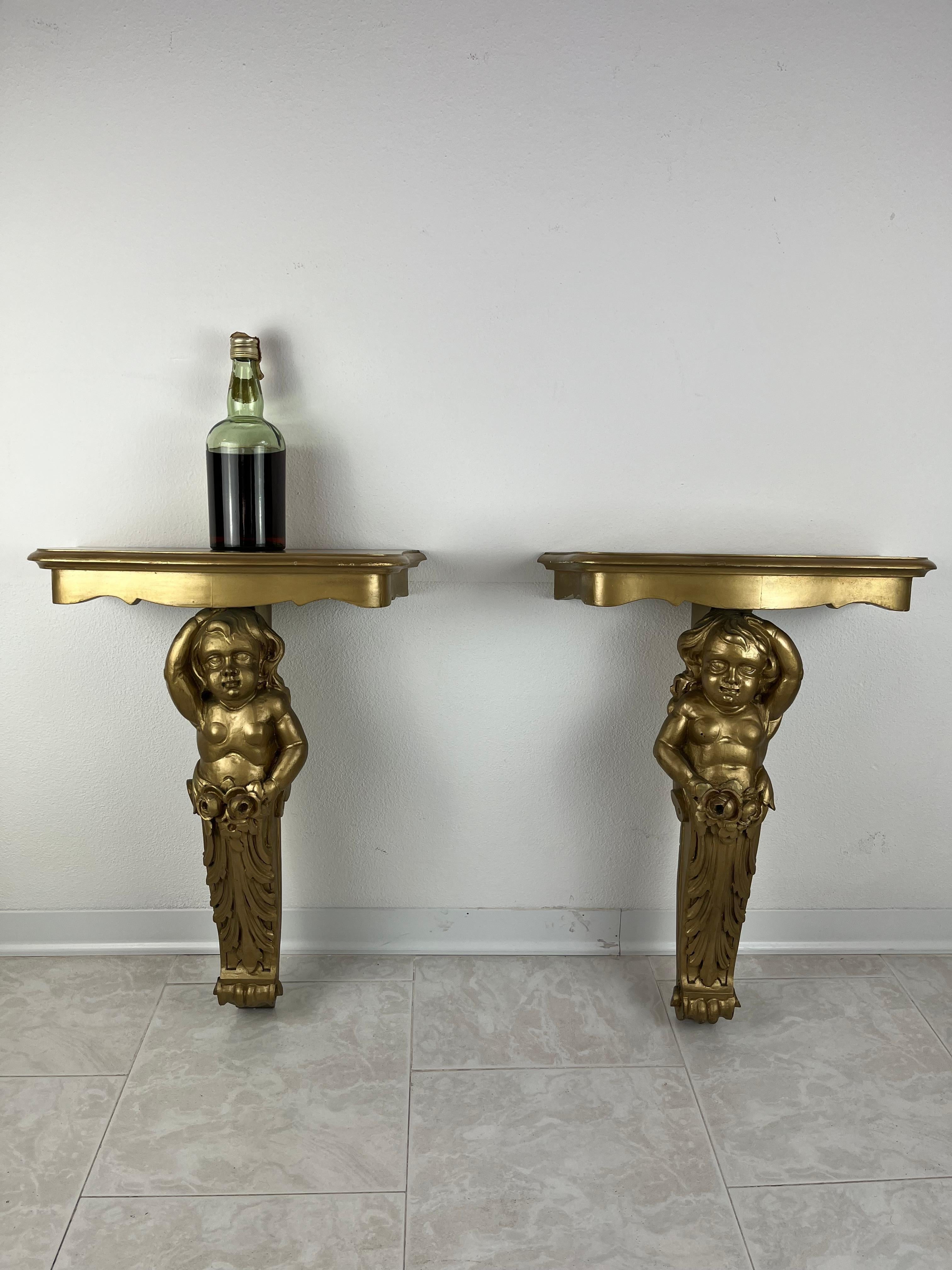 Pair of wall consoles in gilded wood, Italy, 1940s. In the 90s they underwent a conservative restoration and a new gilding was done.