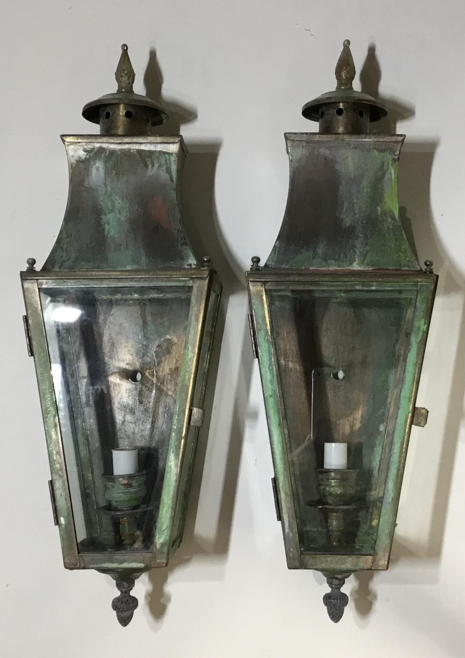 Elegant pair of lantern made of solid brass, nice oxidized patina, with one 60/watt light each. Suitable for wet locations electrified and ready to use. Decorative use indoor too as wall sconces.