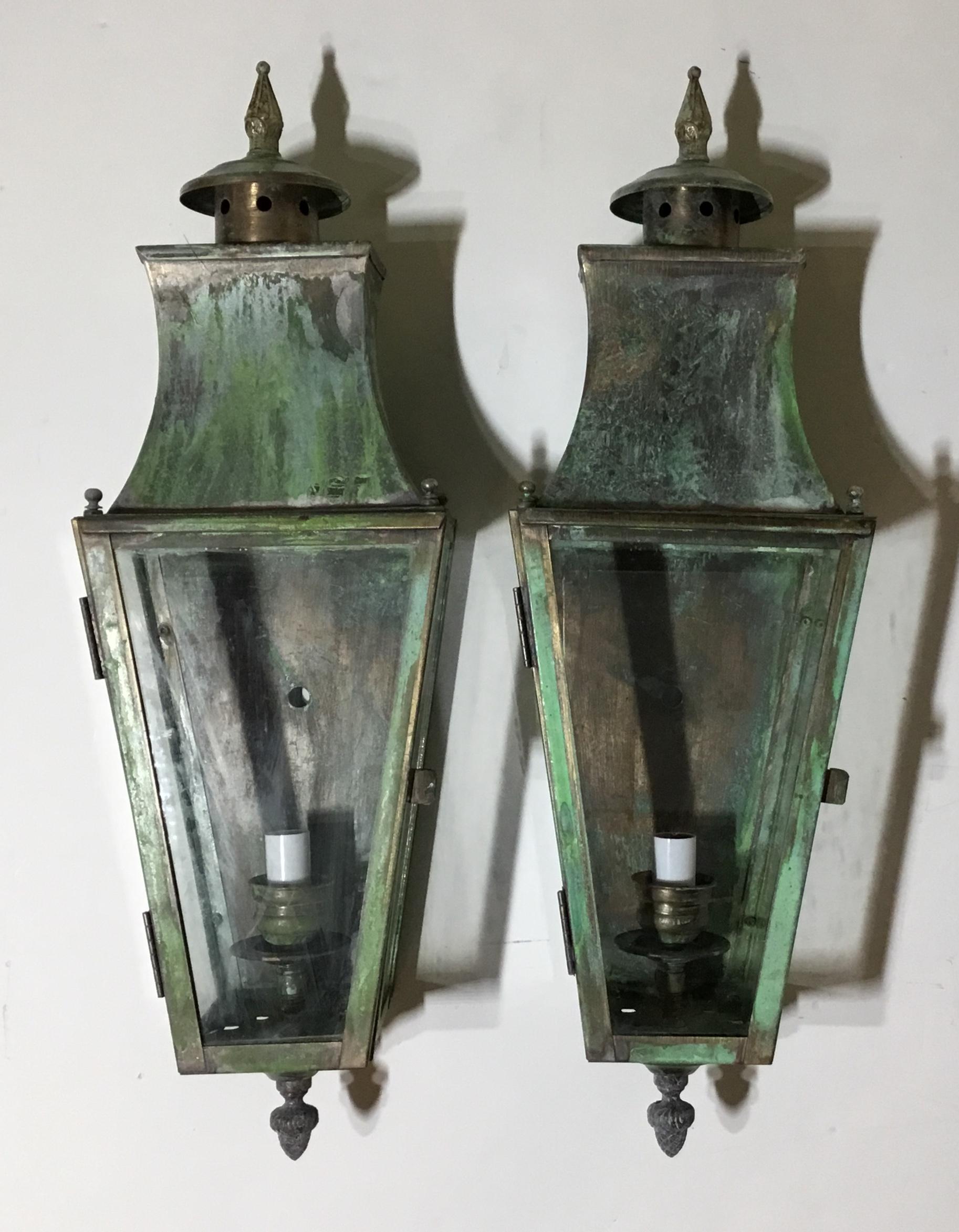 Elegant pair of wall lantern made of solid brass, nice oxidized patina with one 60/watt light each, suitable for wet locations. Electrified and ready to use. Decorative use indoor too as wall sconces.