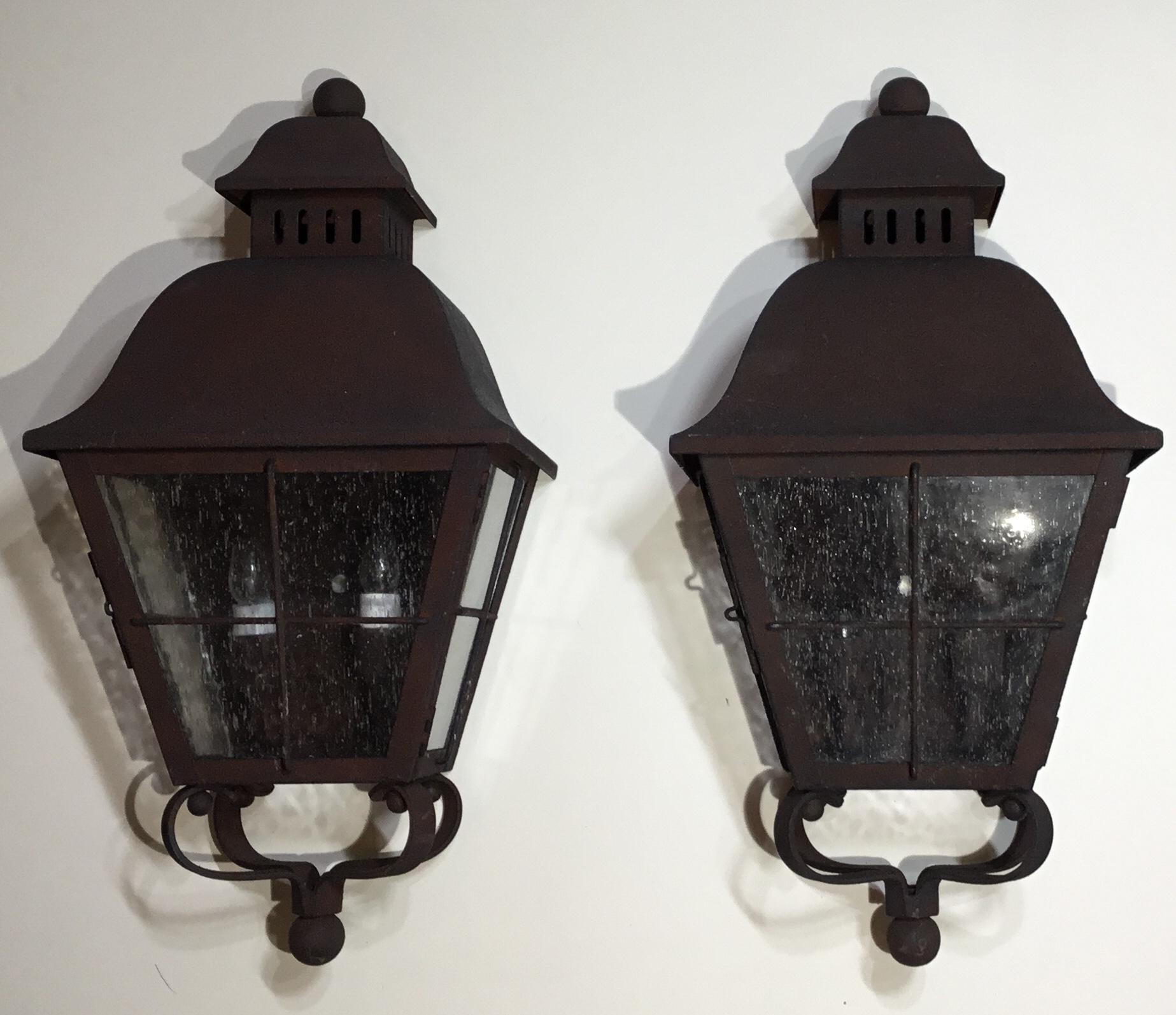 Elagent pair of wall hanging lantern hand forged with solid brass and have professionally rust finish applied, seeded glass. Electrified with tow 40/watt lights each, up to US code, UL approved.
Great decorative pair of lantern.