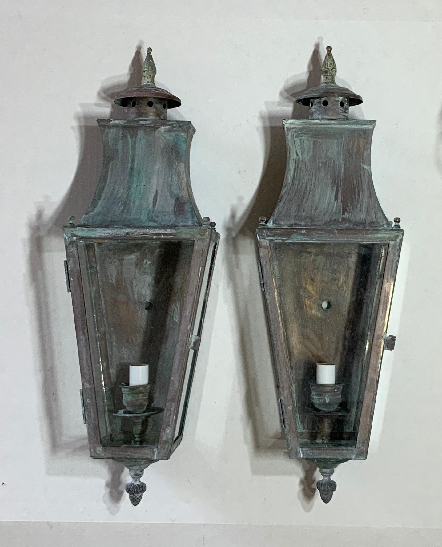 Elegant pair of wall lantern made of solid brass, nice oxidized patina with one 60/watt light each, suitable for wet locations. Electrified and ready to use. Decorative use indoor too as wall sconces.