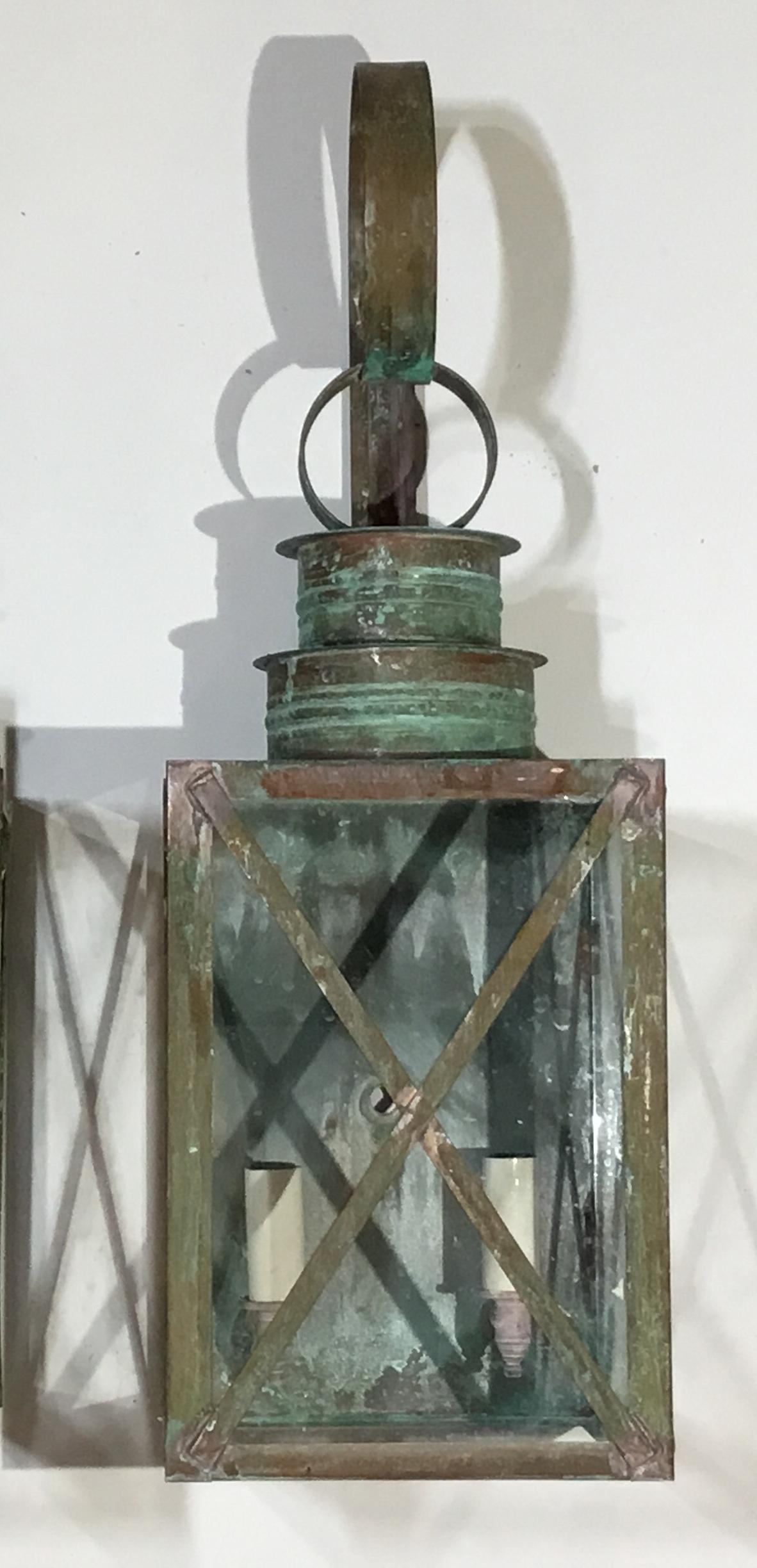 Elegant pair of lantern made of copper electrified and ready to install,
Two 60/watt light on each lantern, up to US code UL approved, suitable for wet locations. Great patina. Will look good outdoors or indoor as wall sconces.