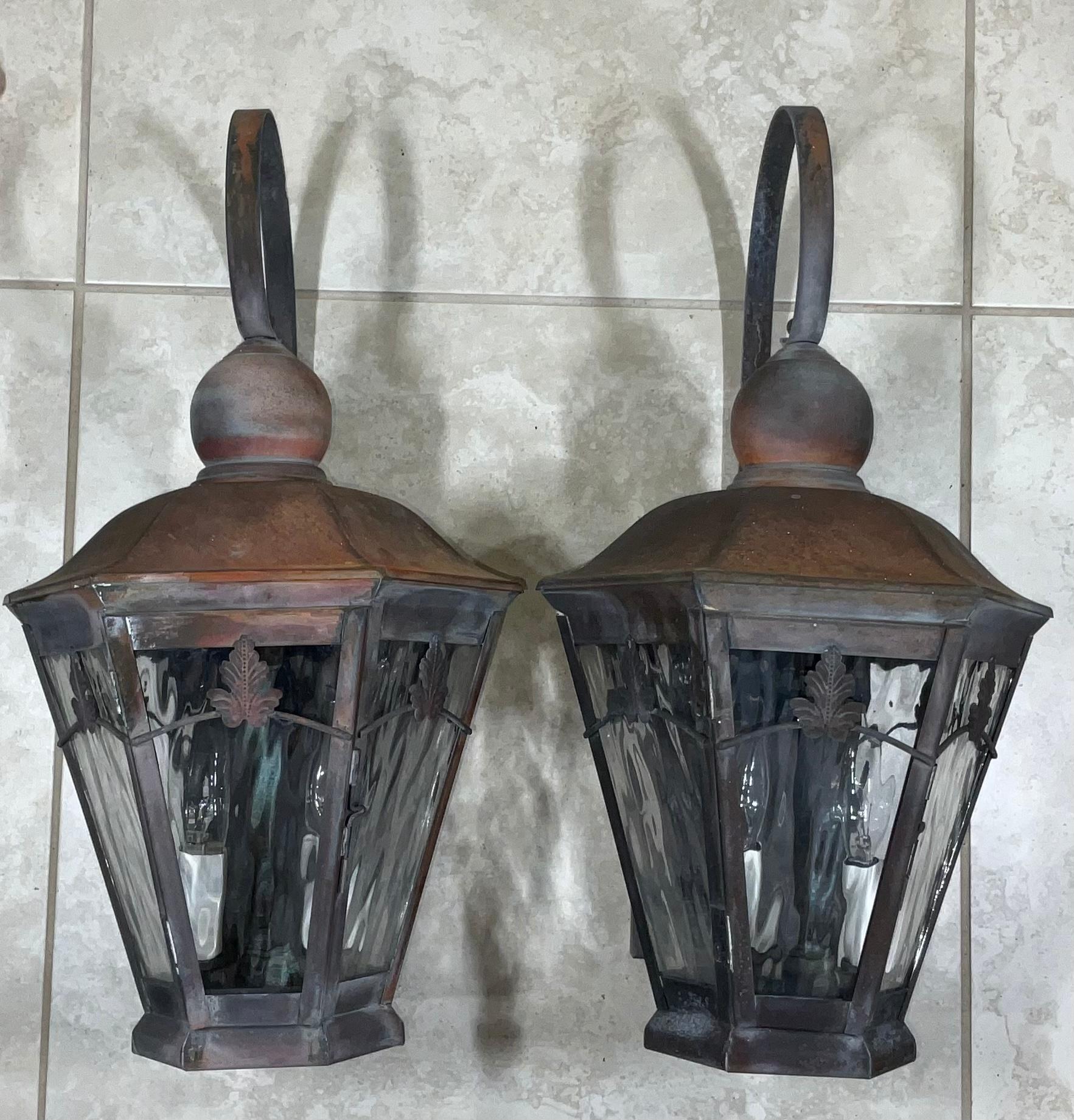 Elegant funky pair of wall hanging lantern made of copper with beautiful patina, electrified with two 60/watt lights each, wavy art glass .UL approved up to US code, suitable for wet locations, great for house entry,
Or even beautiful indoor.
 