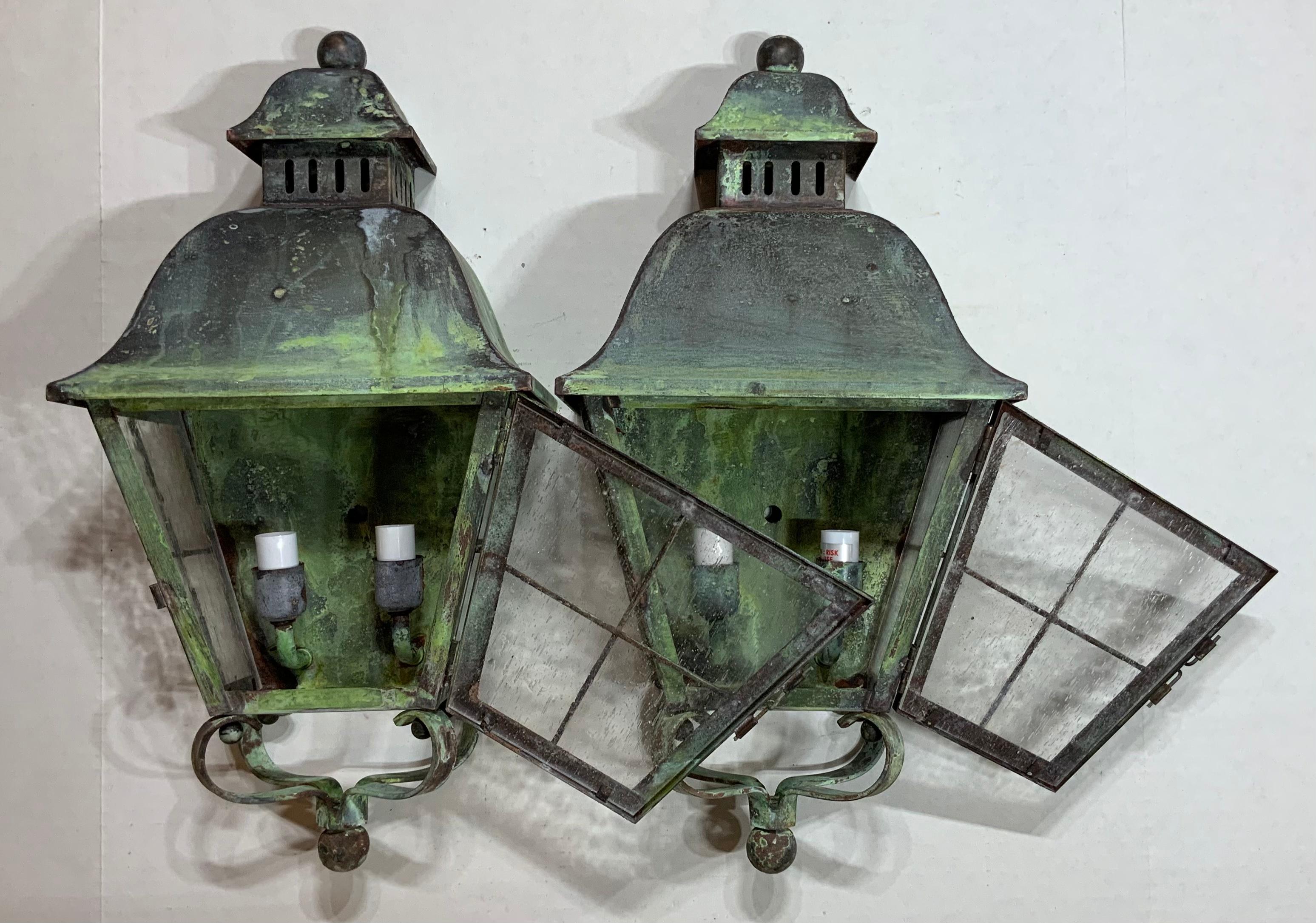 Elegant pair of wall hanging lantern hand forged with solid brass and have beautiful patina, seeded glass. Electrified with tow 40/watt lights each, up to US code, UL approved.
Great decorative pair of lantern. Suitable for wet locations.