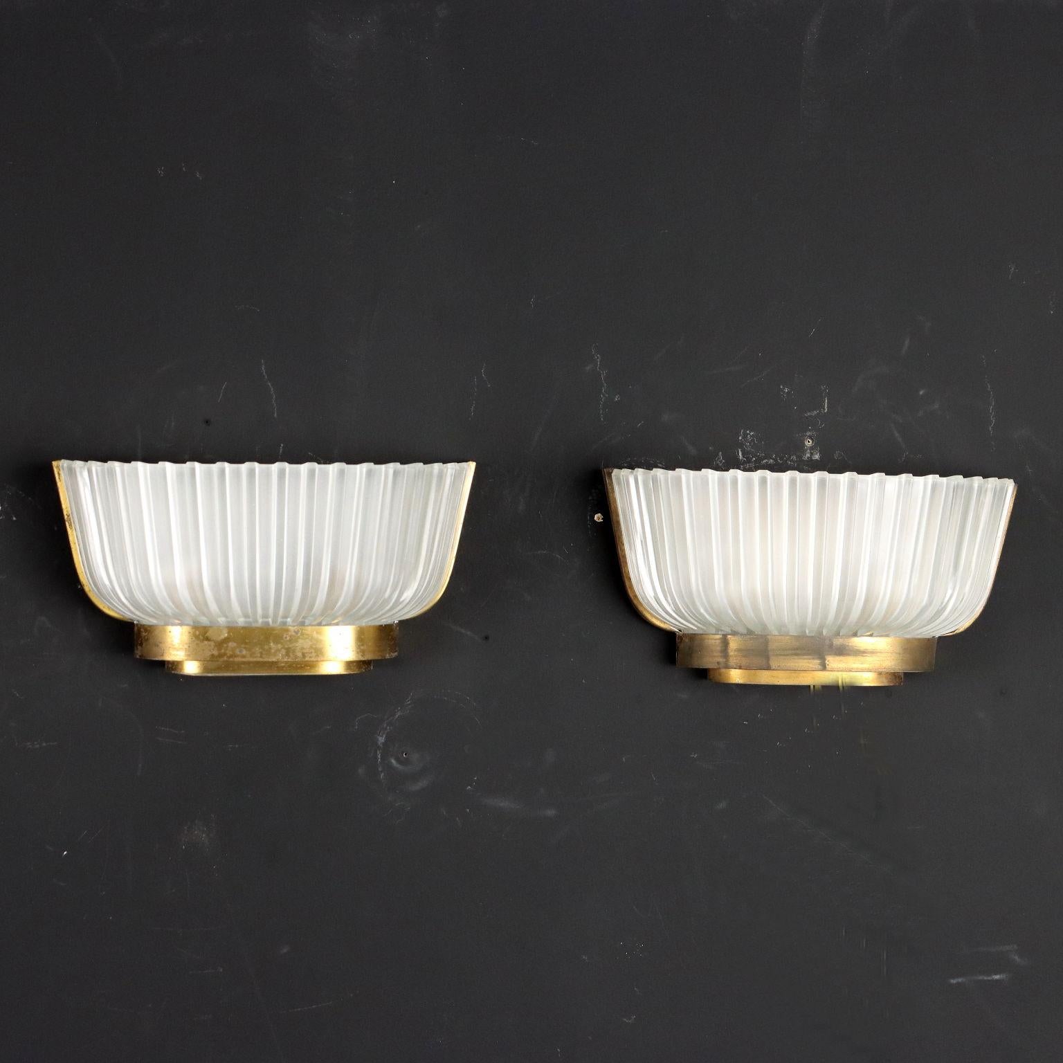 Pair of wall lamps in brass, metal and glass.