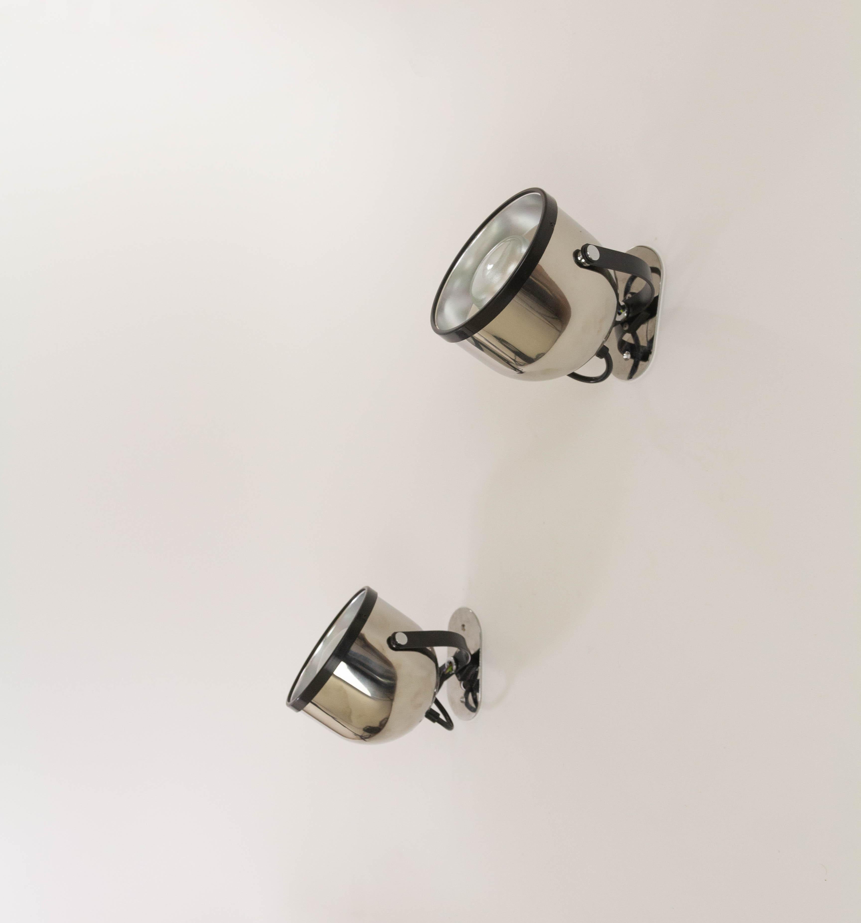 Pair swiveling spots made of chromed metal designed by Gae Aulenti and Livio Castiglioni for Stilnovo in the 1970s. The spots can also be used as ceiling lamps.

The spots or projectors are fitted with a double rotation movement, allowing them to