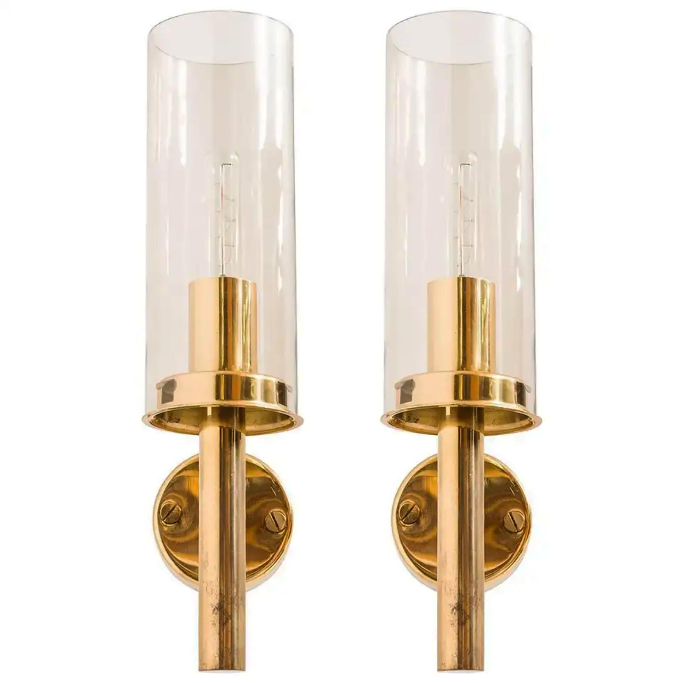 Modernist wall lamps in brass and smoke-colored glass.
Model V 169/14. Designed and made in Sweden by Hans-Agne Jakobsson from circa 1960 second half.
Fully working and in very good vintage condition.
 