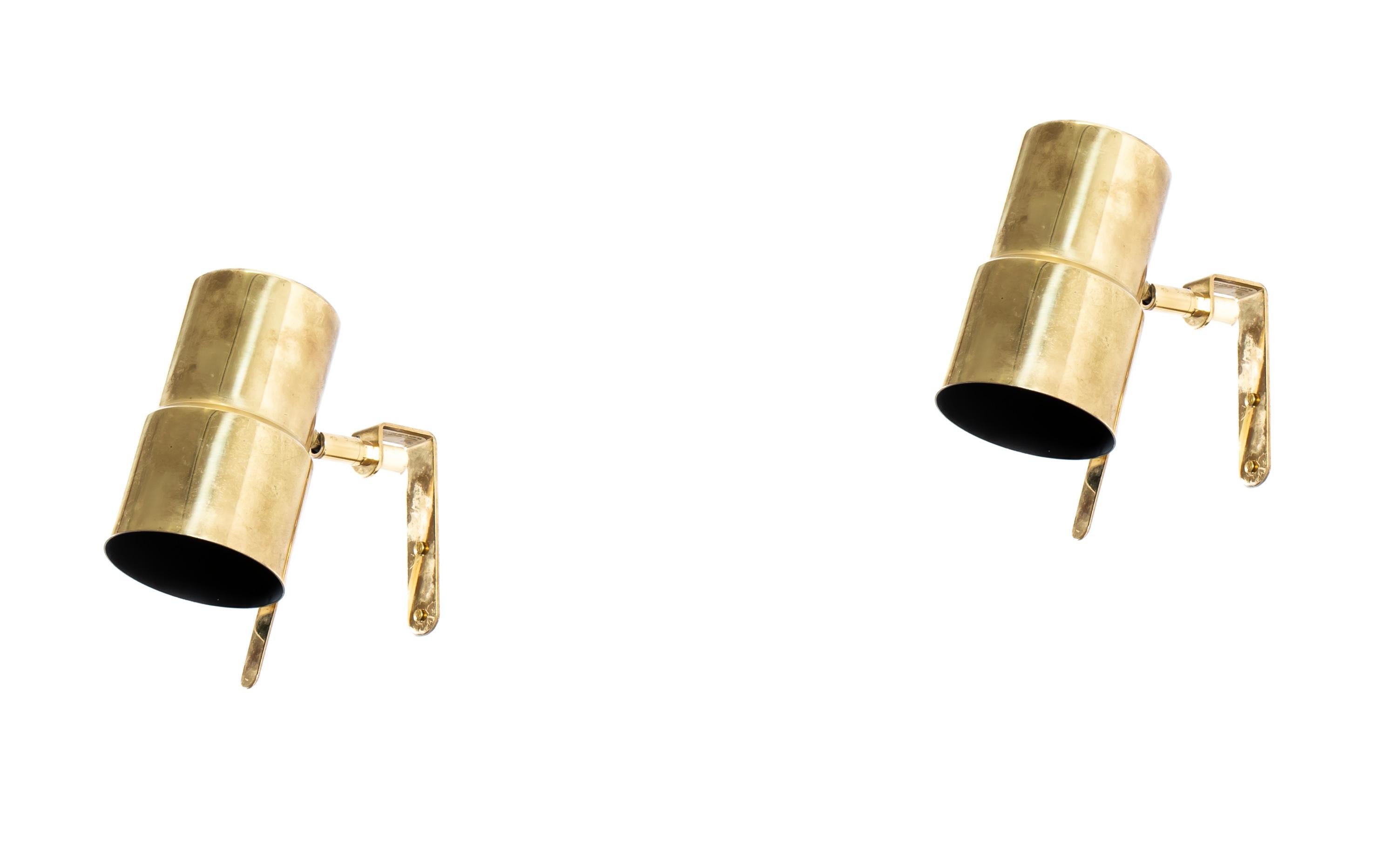 Modernist wall lamps in polished brass. This is Model V-324, designed by Hans-Agne Jakobsson and made by Hans-Agne Jakobsson AB in Markaryd. Both lamps are fully working and in good vintage condition.
