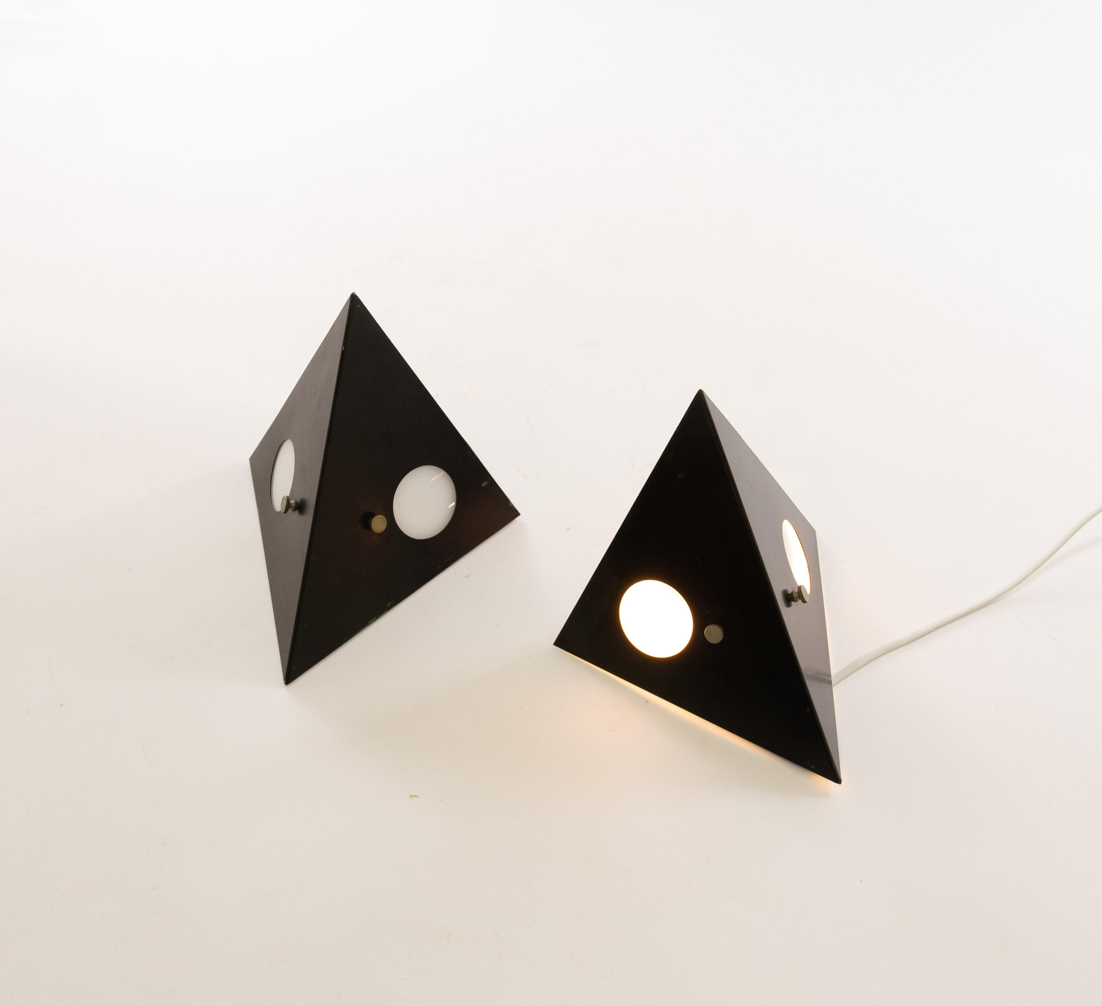 Model no. C-1651, nicknamed 'night owl', designed and manufactured by lighting company RAAK Amsterdam, 1960s. The lamps are intended as wall lamp, but they can also function as a table lamps. The two circular lights can be dimmed