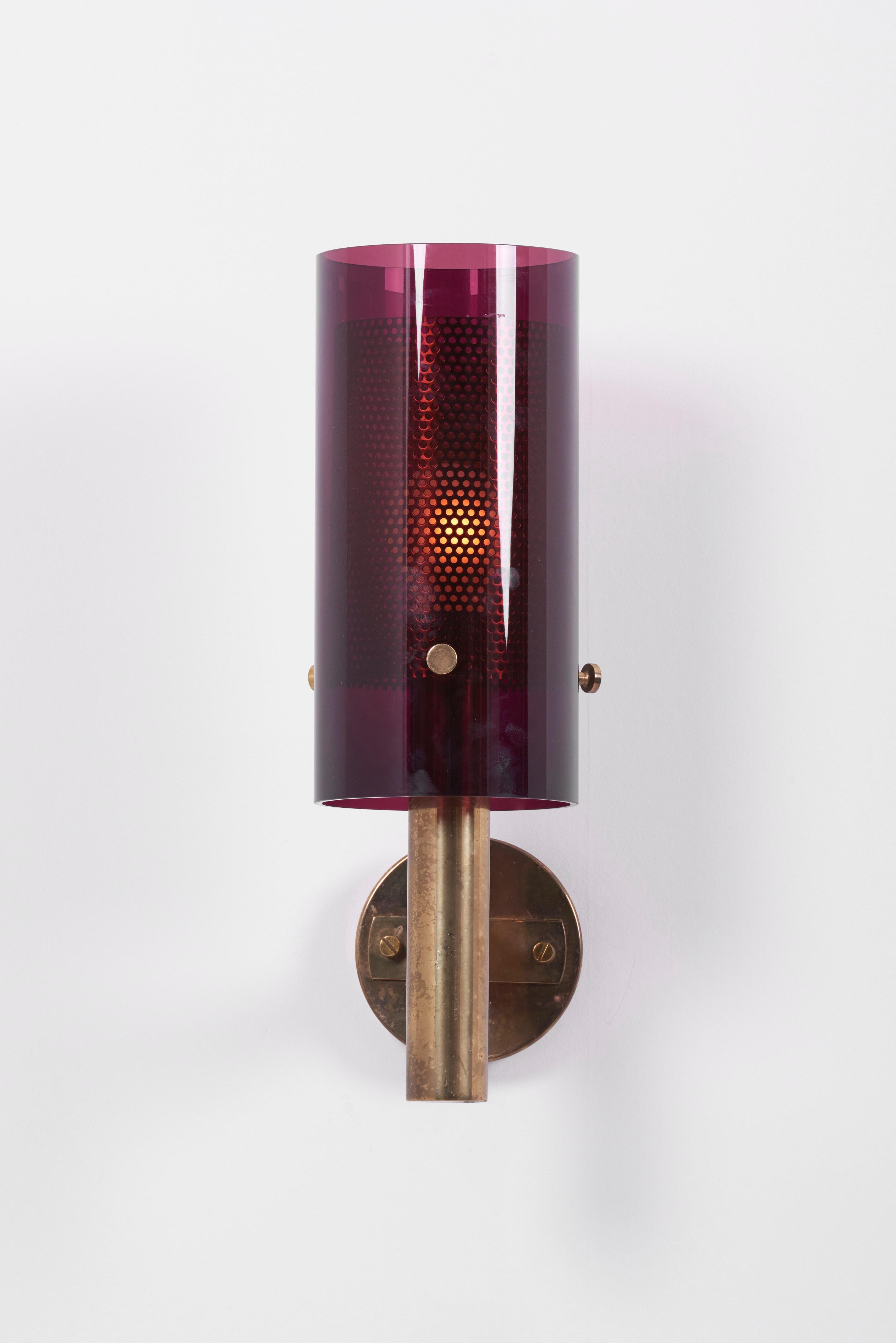 Rare pair of wall lamps, model V-147, designed by Hans-Agne Jakobsson for Hans-Agne Jakobsson AB in Markaryd, Sweden, labeled.
Brass base and purple tinted glass with perforated sheet inside, fixed by three screws each.
Original condition with