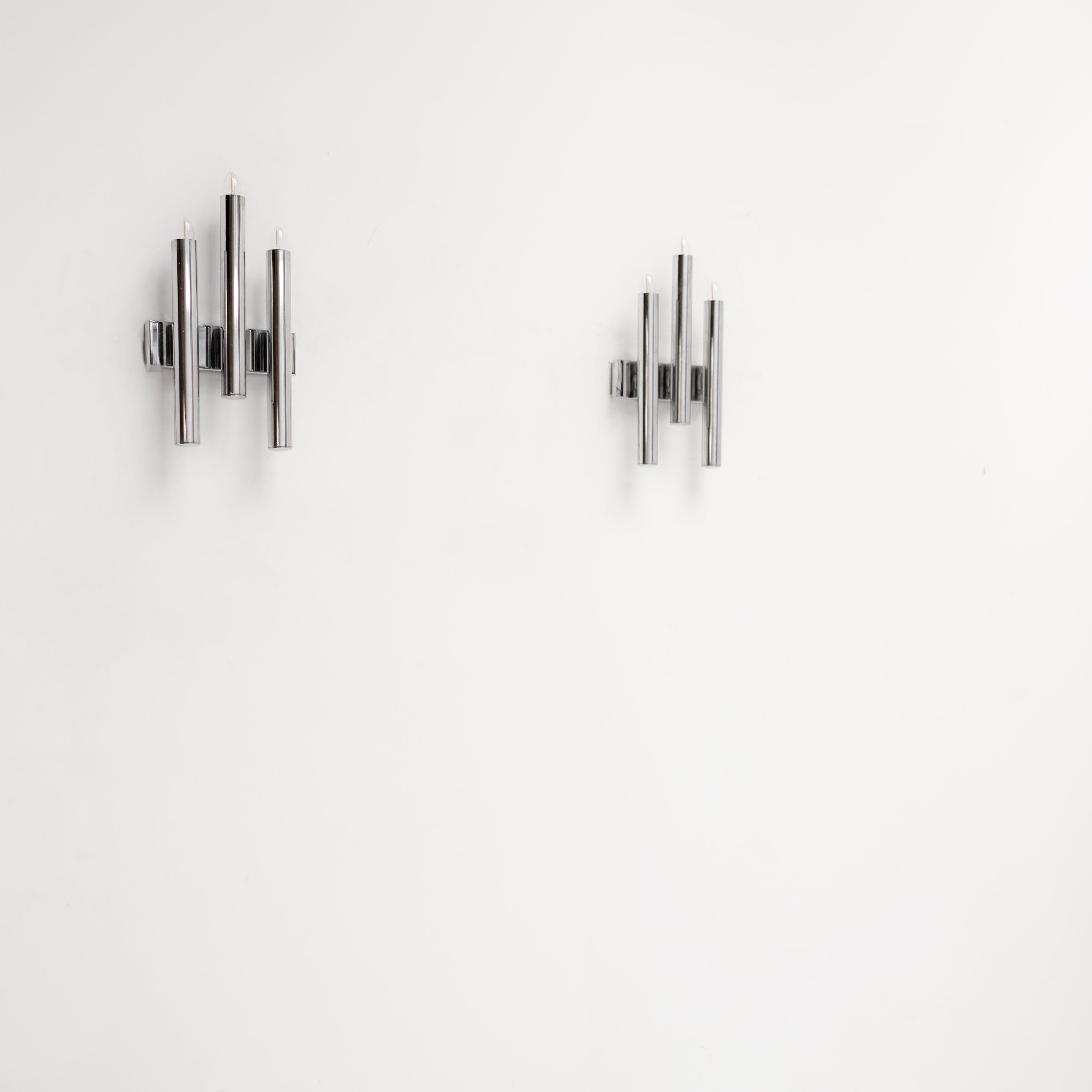Exceptional pair of Italian wall sconces designed by Gio Ponti. Featuring sculptural arrangements of polished chrome tubes, these fixtures reflect Ponti’s signature balance of modernist clarity and architectural sophistication. The bold vertical