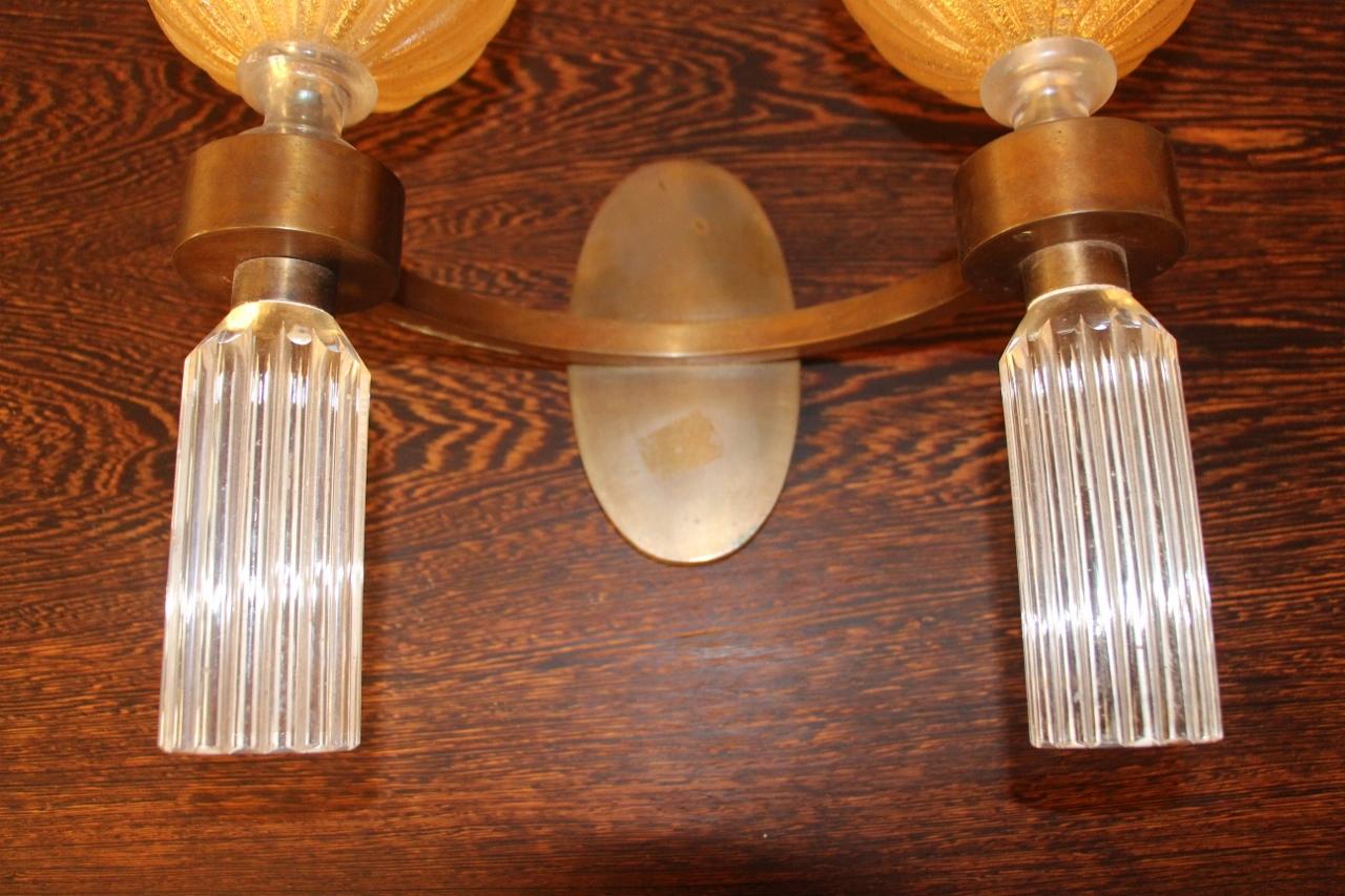 Elegant pair of wall lights with gilt bronze frame with two light arms with baluster and gadrooned corollas and trimmings in coroso glass mixed with gold spangles and white glass in perfect electrified condition possibility of two additional pairs.