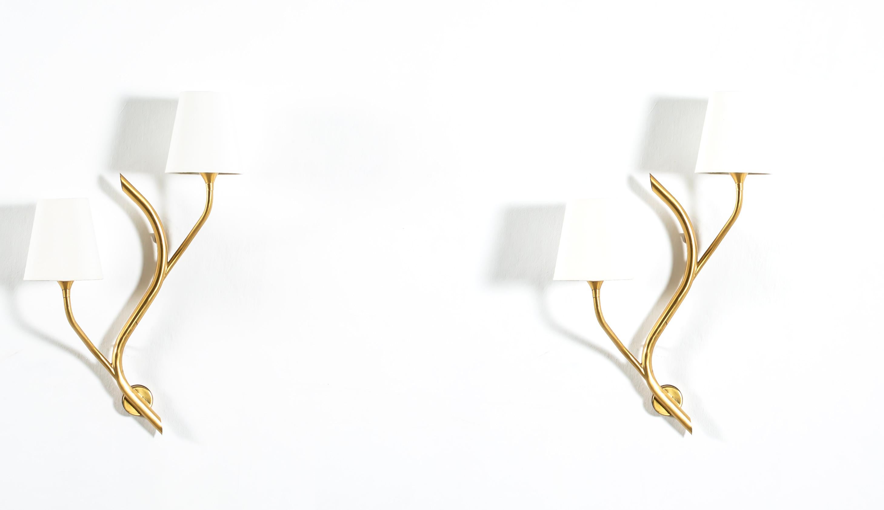 Sculptural and organically shaped pair of two-armed wall lamps in brass. The lamps are designed and made in Norway by Astra from circa 1960s second half. Both lamps are fully working and in very good vintage condition. Each lamp is fitted with two