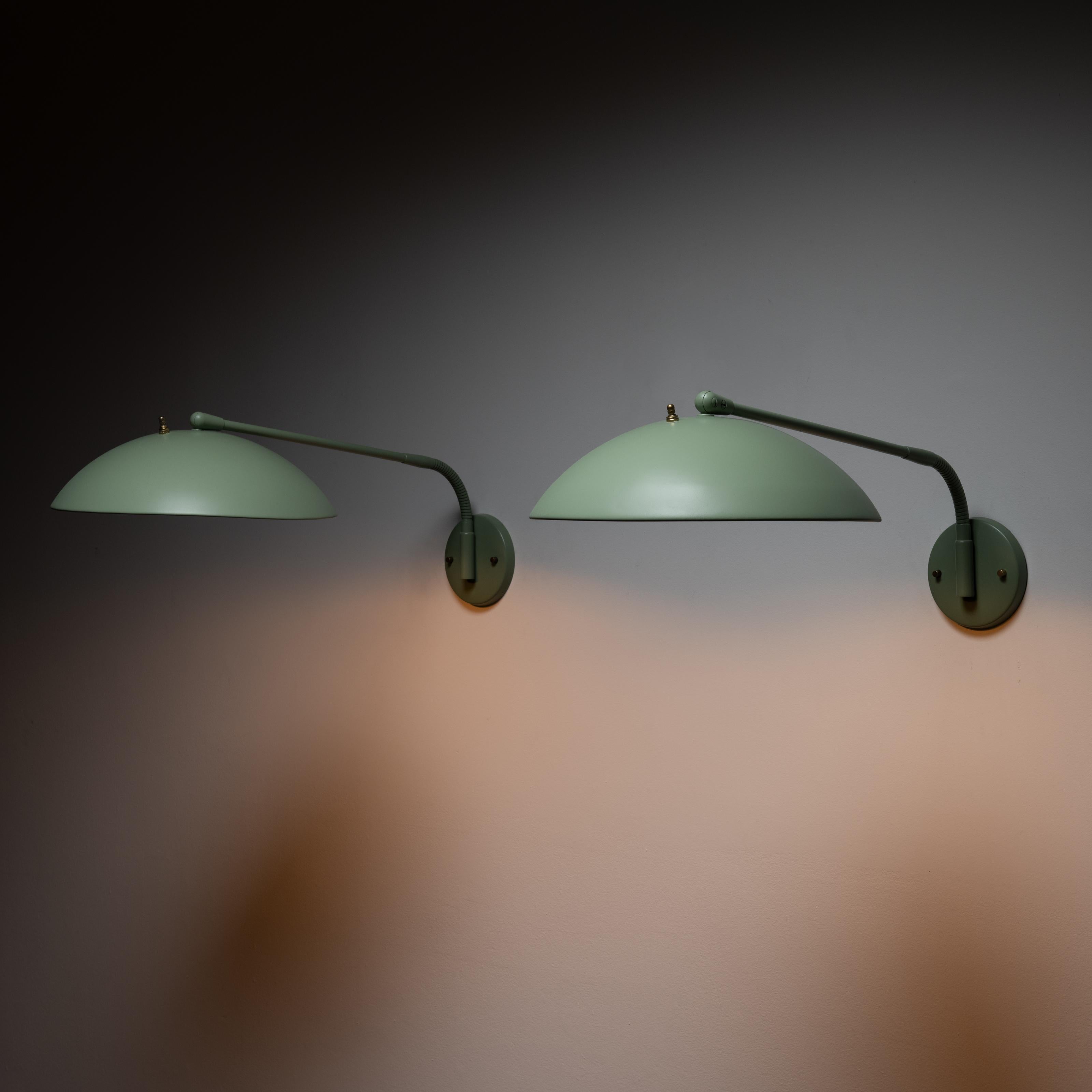 Pair of wall lights by Kurt Versen. Designed and manufactured in the USA, circa 1948. Flexible stem arms allow for multiple positions on these wall lights. Push button on top of the shades for a secondary switch point once hardwired. Recently