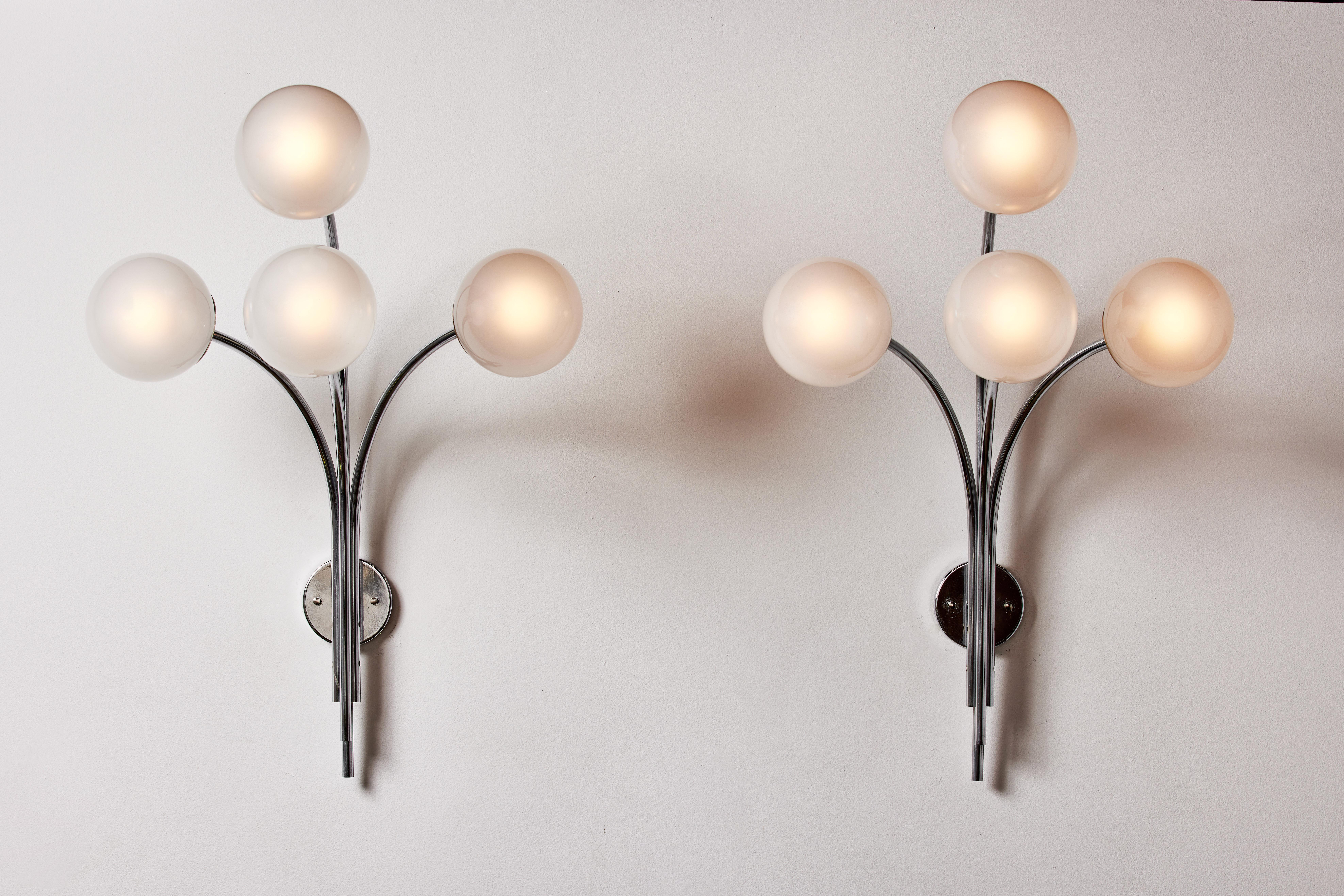 Pair of model 257 wall lights by Sergio Asti for Arteluce. Designed and manufactured in Italy, circa the 1960s. Frosted glass diffusers, chrome armature. Retains original manufacturer's label. Wired for U.S. standards. We recommend 40w maximum