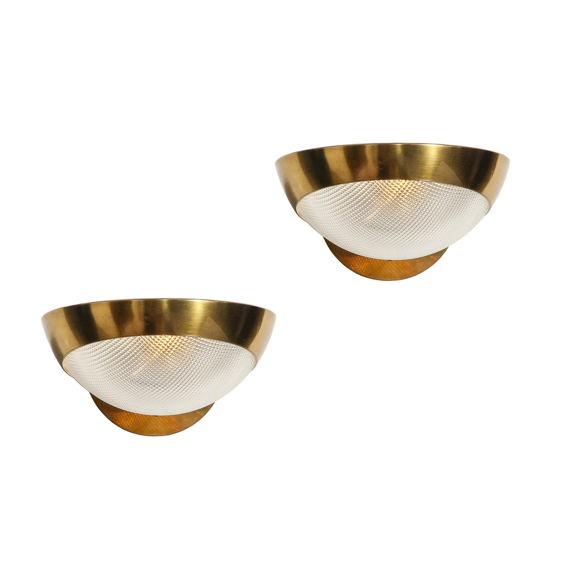 The pair of brass wall lights by Stilnovo with original labels. The glass shades have been remade to the original form and type.