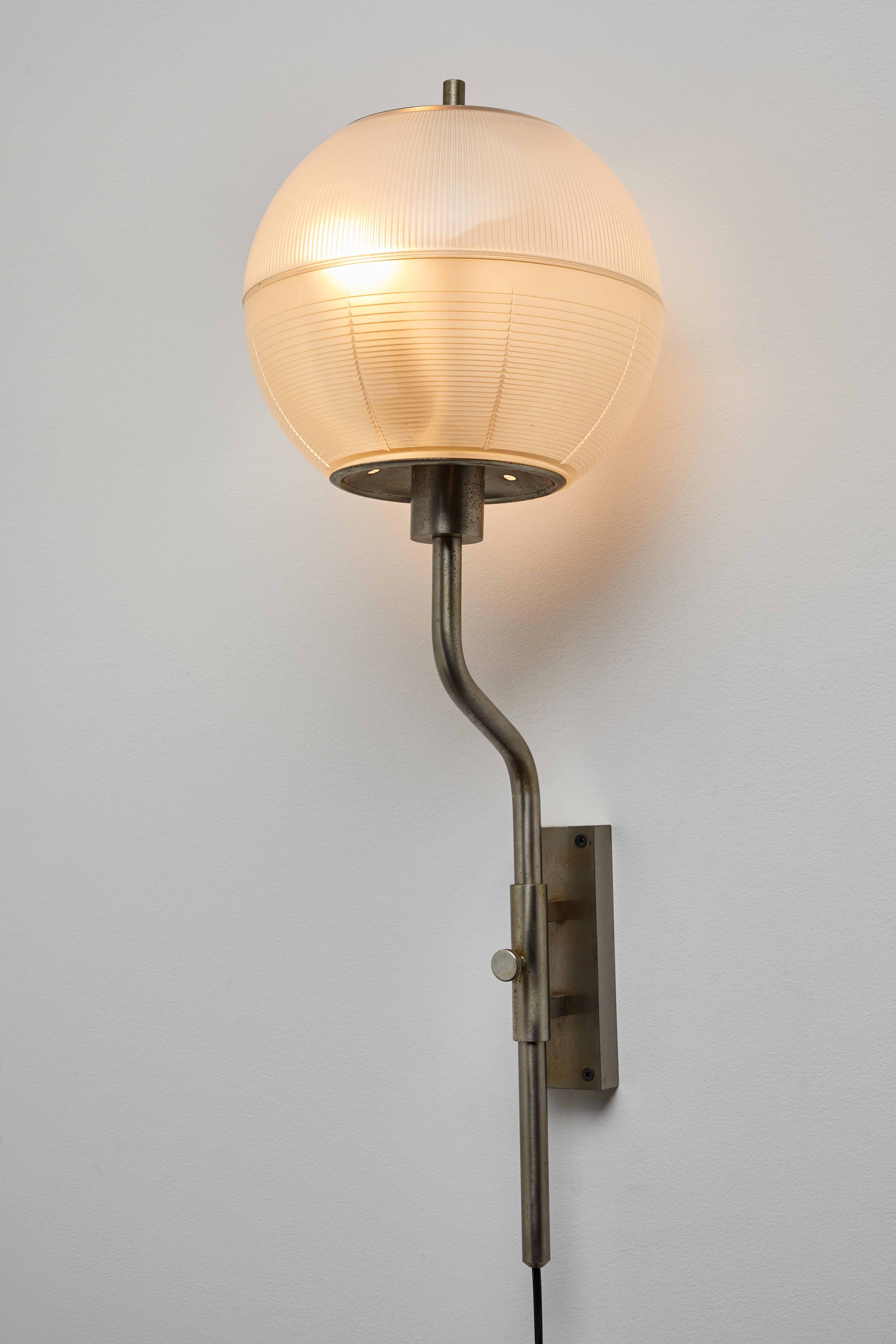 Pair of wall lights by Stilnovo. Manufactured in Italy, circa 1960. Textured glass, brass-plated pewter. Rewired for U.S. junction boxes. Each light takes two E27 75w maximum bulbs. Bulbs provided as a one time courtesy.