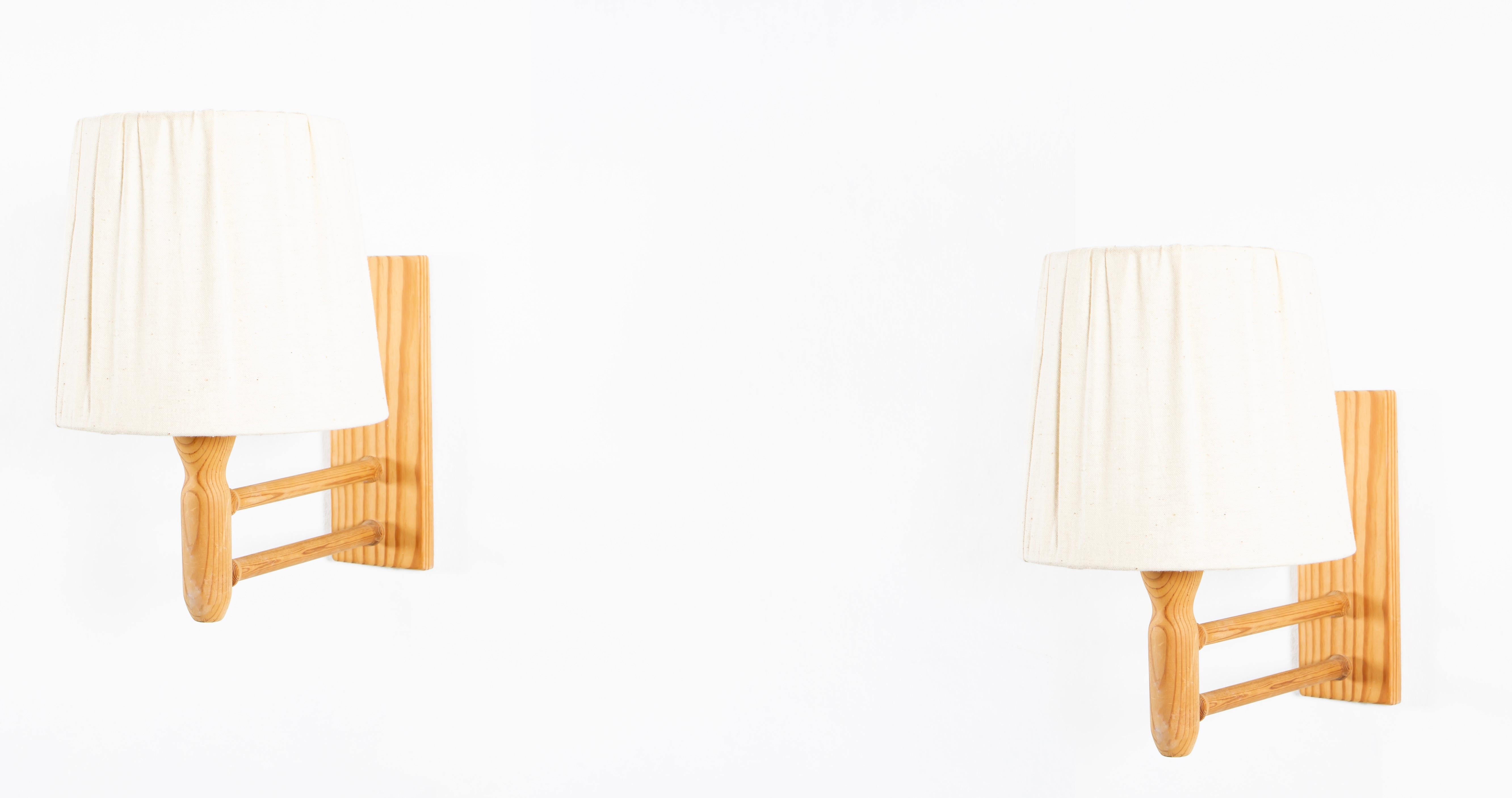 Sculptural wall lamps in pine with shades in fabric. Designed by Alf Sture and made in Norway from cirka 1960 second half. Both lamps are fully working and in good vintage condition. Each lamp is fitted with one E27 bulb holder (works in the US),