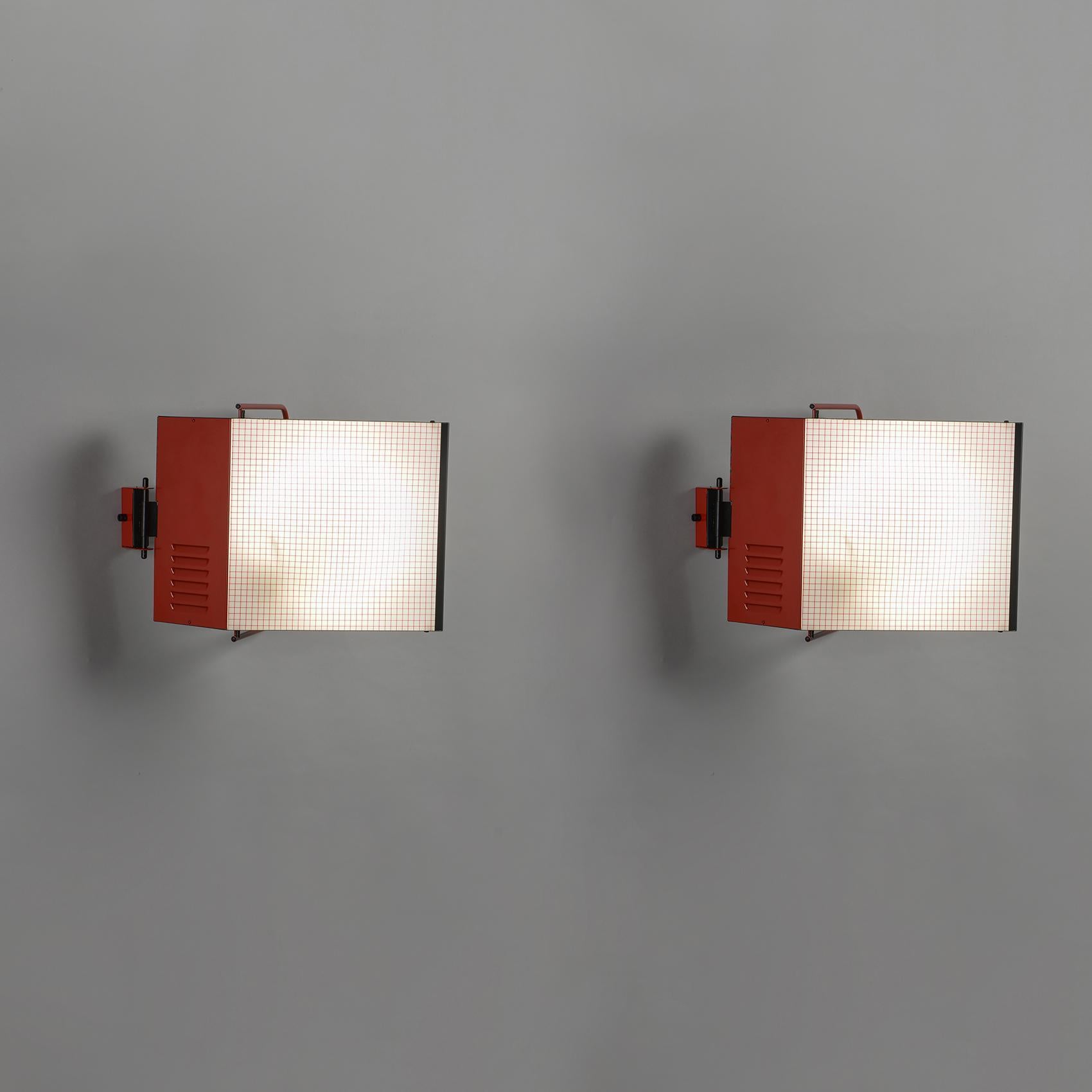 Pair of model 3410 sconces, known as Cabriolet, with one arm of light in red lacquered metal holding a reflector with two circular neon lights under white opaline glass.

Marked Stilnovo on the cover.

A wall lamp in its original box.
