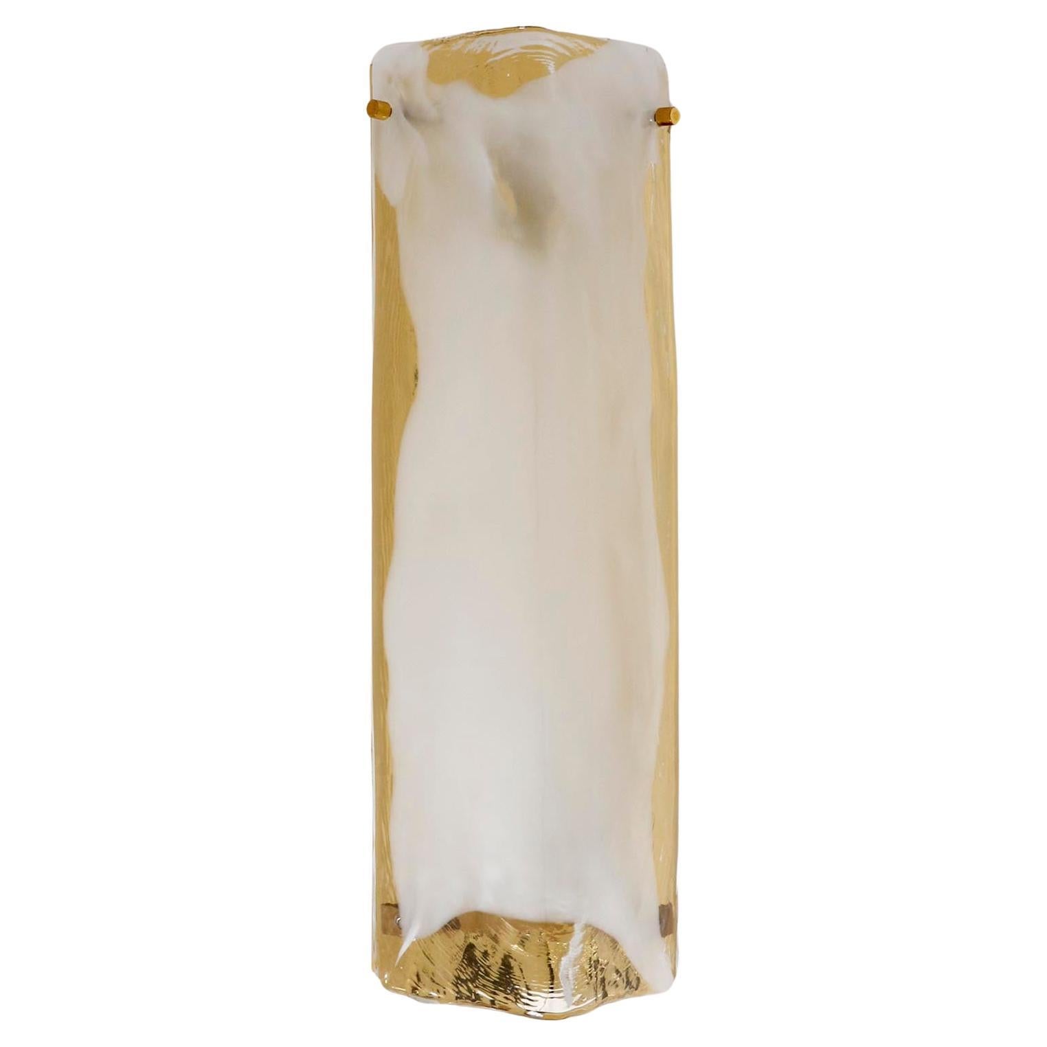 A pair of large wall lights model 'Ango' by Kalmar, Austria, manufactured in Mid-Century, circa 1970.
A polished brass backplate holds a clear, white or mother-of-pearl-colored angled Murano glass piece.
There is a minor difference in the hue of the