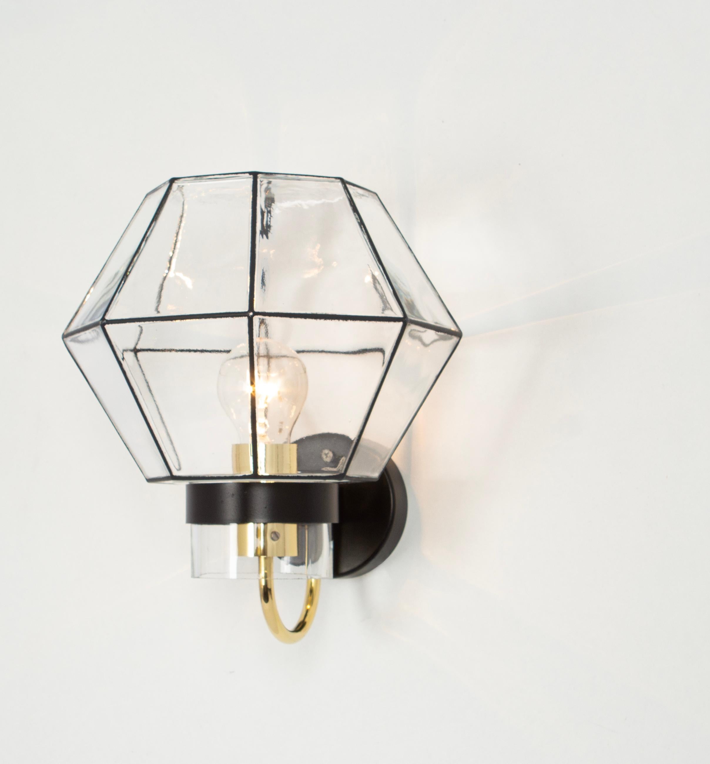 Pair of  Beautiful wall lights with a unique 'iron' design by Glashütte Limburg, Germany. Manufactured in midcentury, circa 1960.
Black 'iron' squares inlaid in thick clear glass. Newly rewired.

High quality and in very good condition. Cleaned,