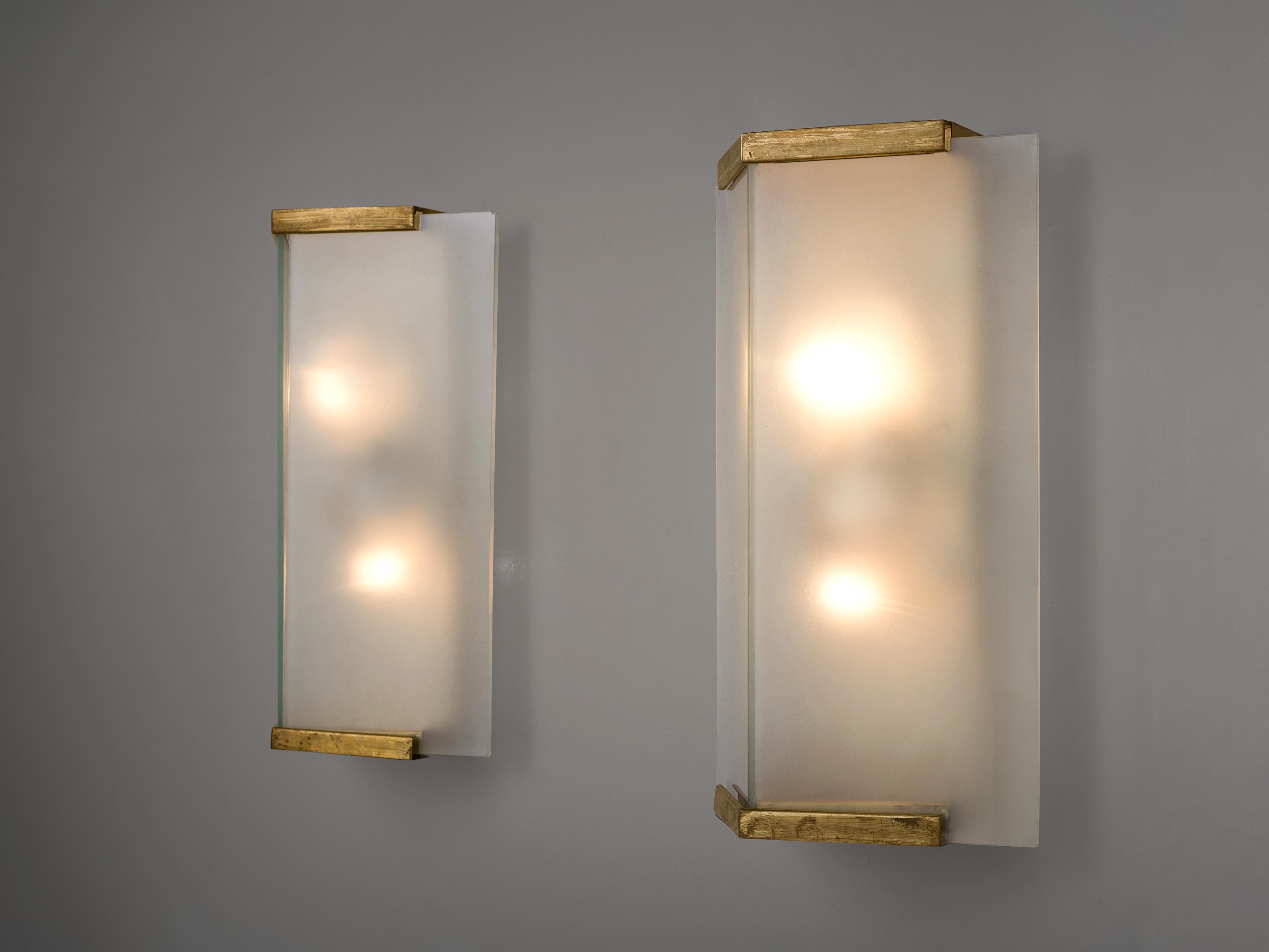 Pair of wall light, brass, frosted glass, Europe, 1930s.

These simplistic geometric sturdy wall lights give off a warm light partition thanks to the thick, high-quality glass. The lights feature a double, symmetrical lay-out with triangle glass