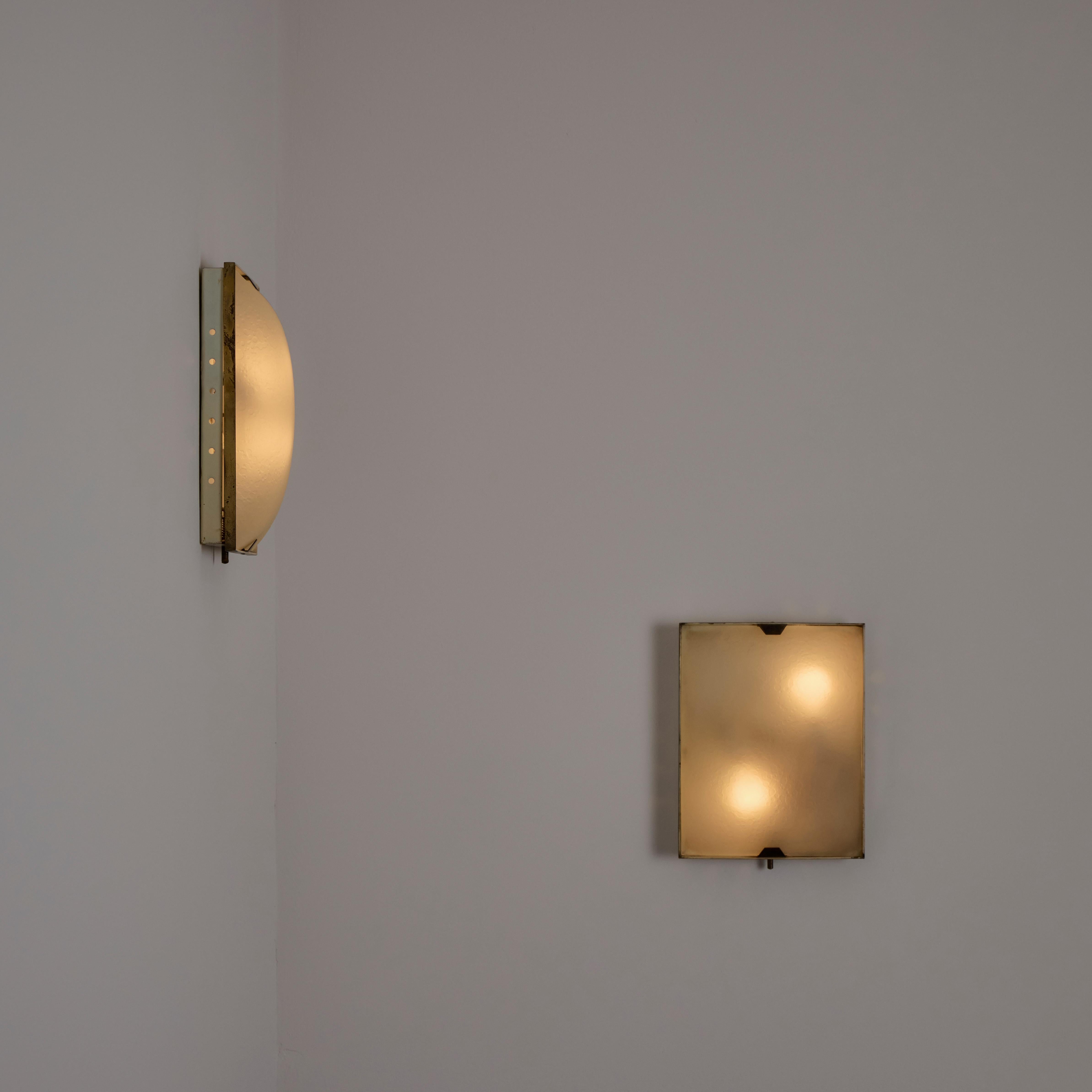 Flush Mounts by Stilnovo. Designed and manufactured in Italy, circa the 1950s. Square framed housing with textured turtle-shell glass. Each sconce holds a dual-socket lamping construction. We recommend a 25-40w max bulb or LED equivalent. Sold