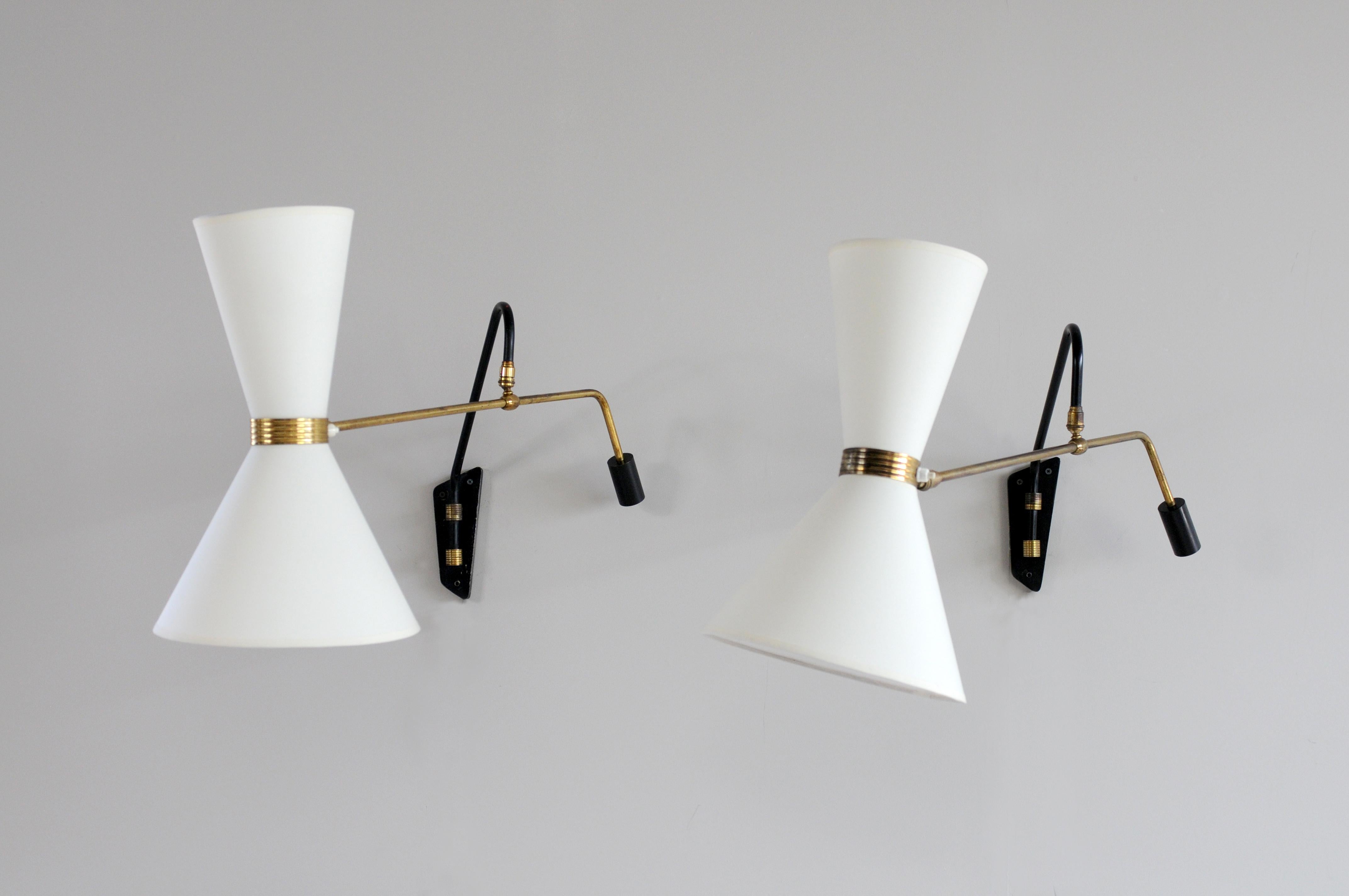 Rare pair of wall sconces from Lokiec establishments in black lacquered tubular metal and gilded brass, France, 1950. Listed under number 240, (number under the base), these luminaires have a large diabolo lampshade with dual ignition and several